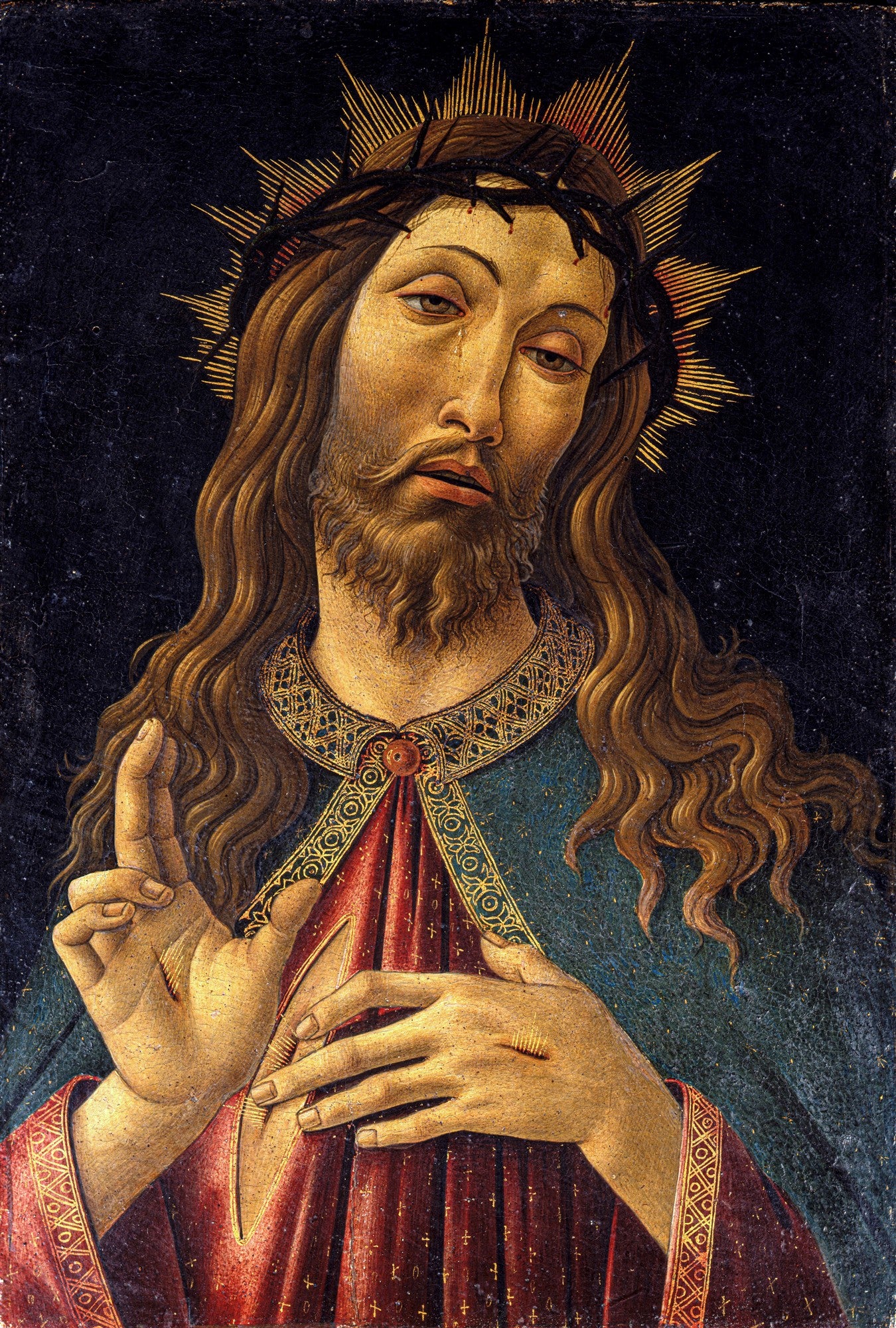 Quadro decorativo mostrando Jesus Cristo com coroa de espinhos, barba e cabelos longos, lágrimas nos olhos, com uma das mãos levantada em bênção e a outra sobre o peito, exibindo as chagas. Fundo escuro.