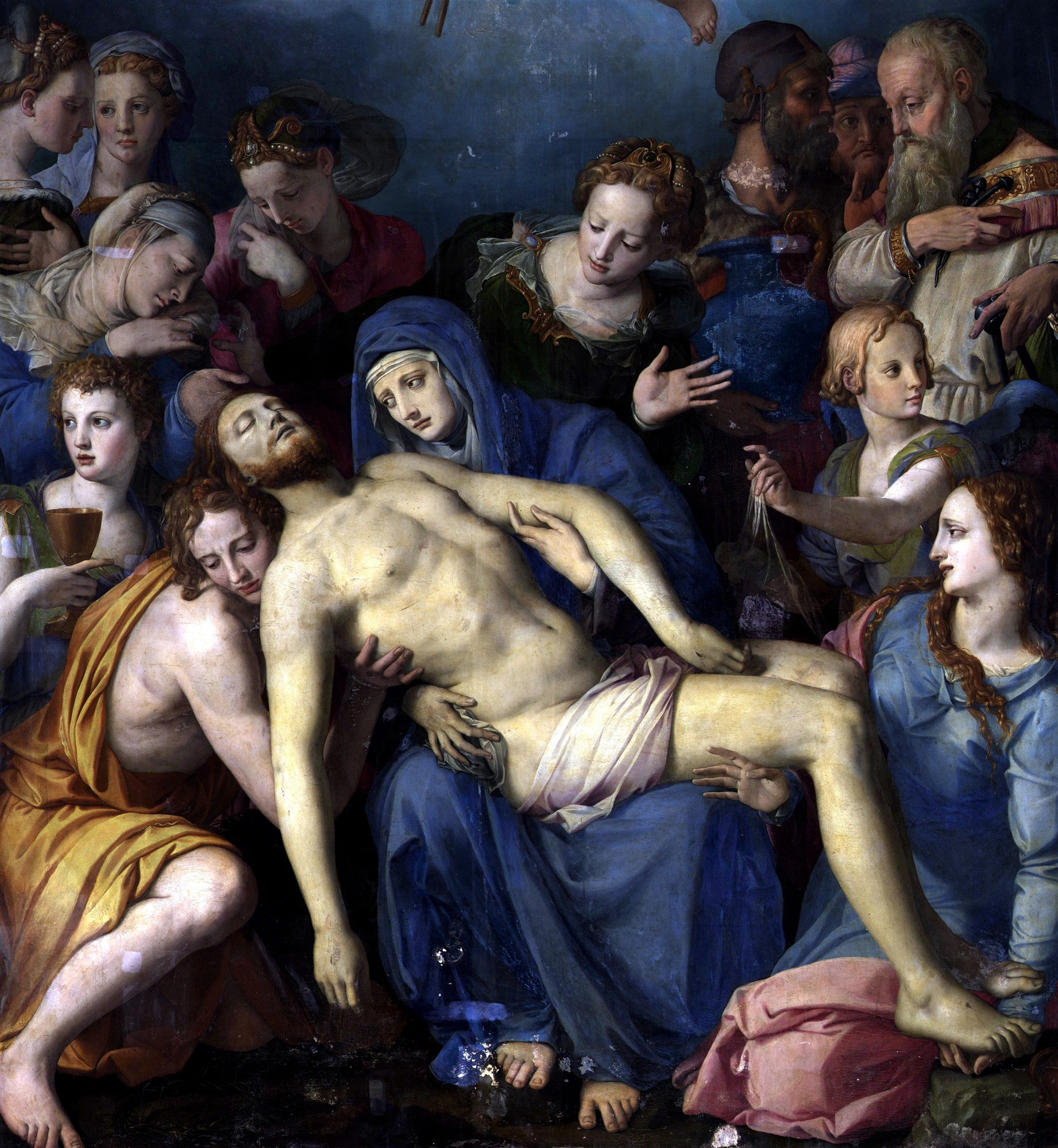 Quadro decorativo da pintura 'Lamentação de Cristo' de Bronzino, representando Maria segurando o corpo de Cristo morto, cercada por figuras em luto e compaixão. As cores são ricas e os rostos expressivos, com tons de azul, vermelho e dourado predominando.