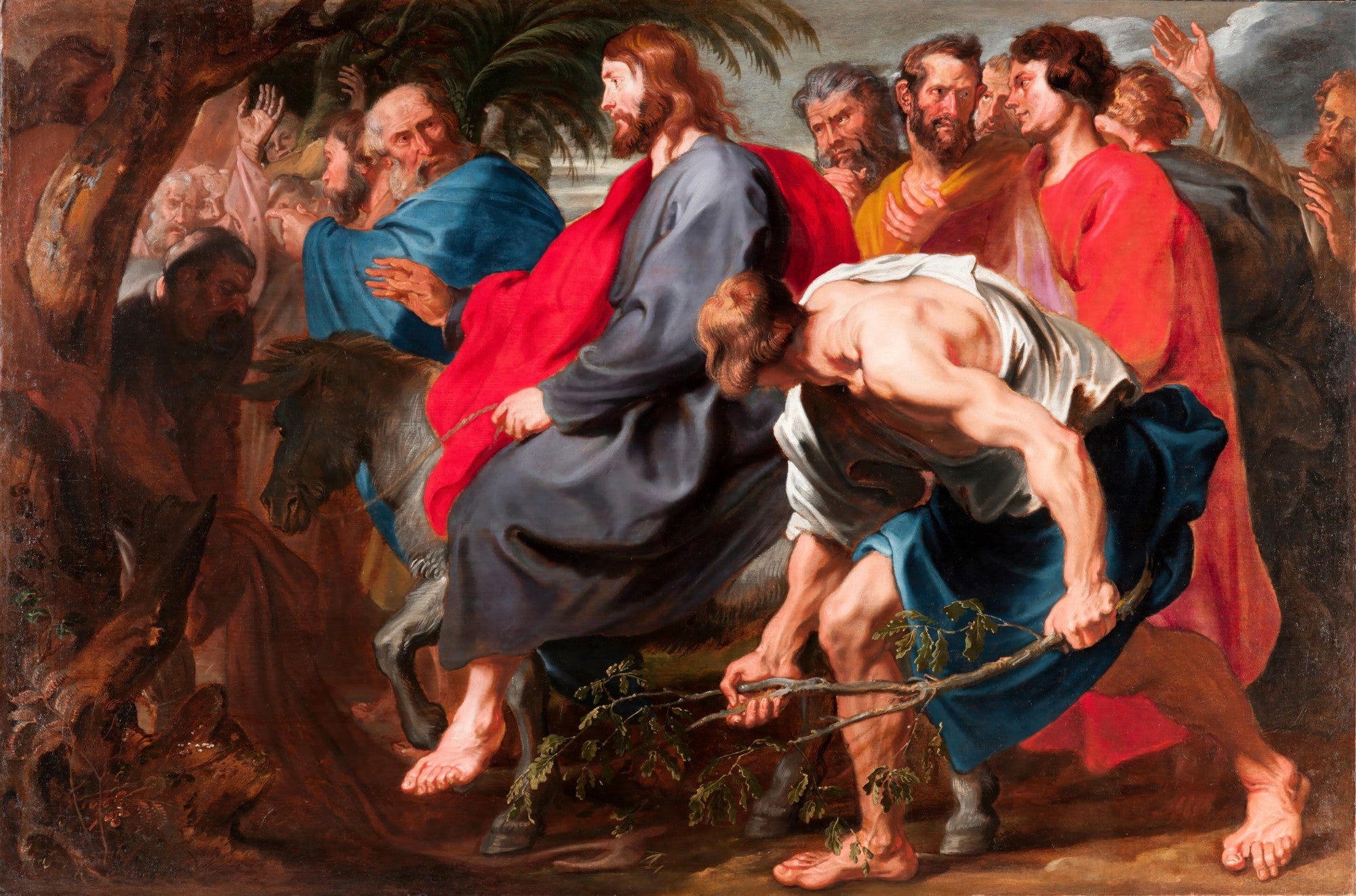 Quadro decorativo mostrando Jesus montado em um jumentinho, entrando em Jerusalém, com uma multidão ao seu redor, alguns jogando ramos no chão. Obra de Anthony van Dyck.