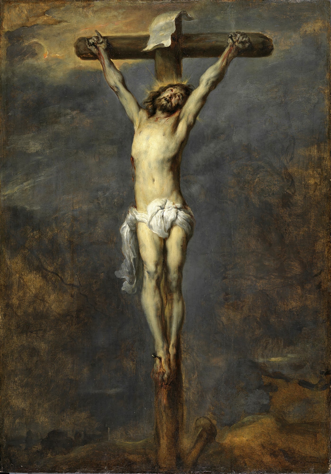 Pintura a óleo de "A Crucificação" de Anthony van Dyck, mostrando Cristo na cruz com um corpo pálido e musculoso, um pano branco cobrindo a cintura, contra um céu escuro e tempestuoso. A cruz é de madeira escura e há um pergaminho no topo. A iluminação dramática realça a figura de Cristo.