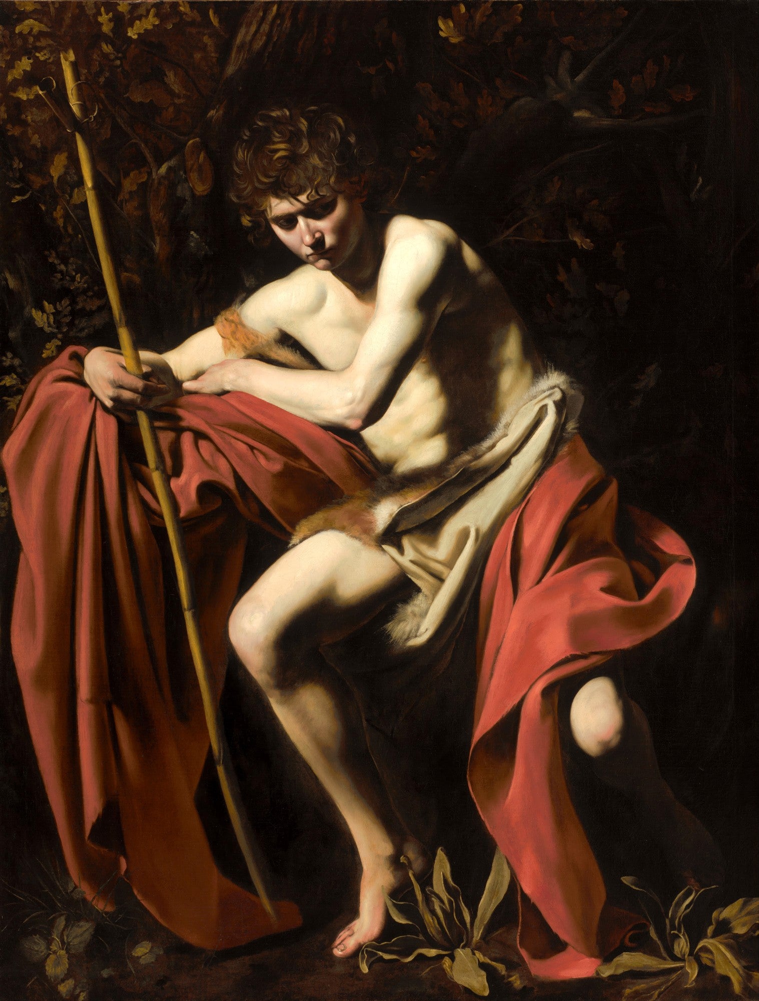 Quadro decorativo do São João Batista de Caravaggio, jovem nu com manto vermelho e cajado em cenário escuro e dramático.