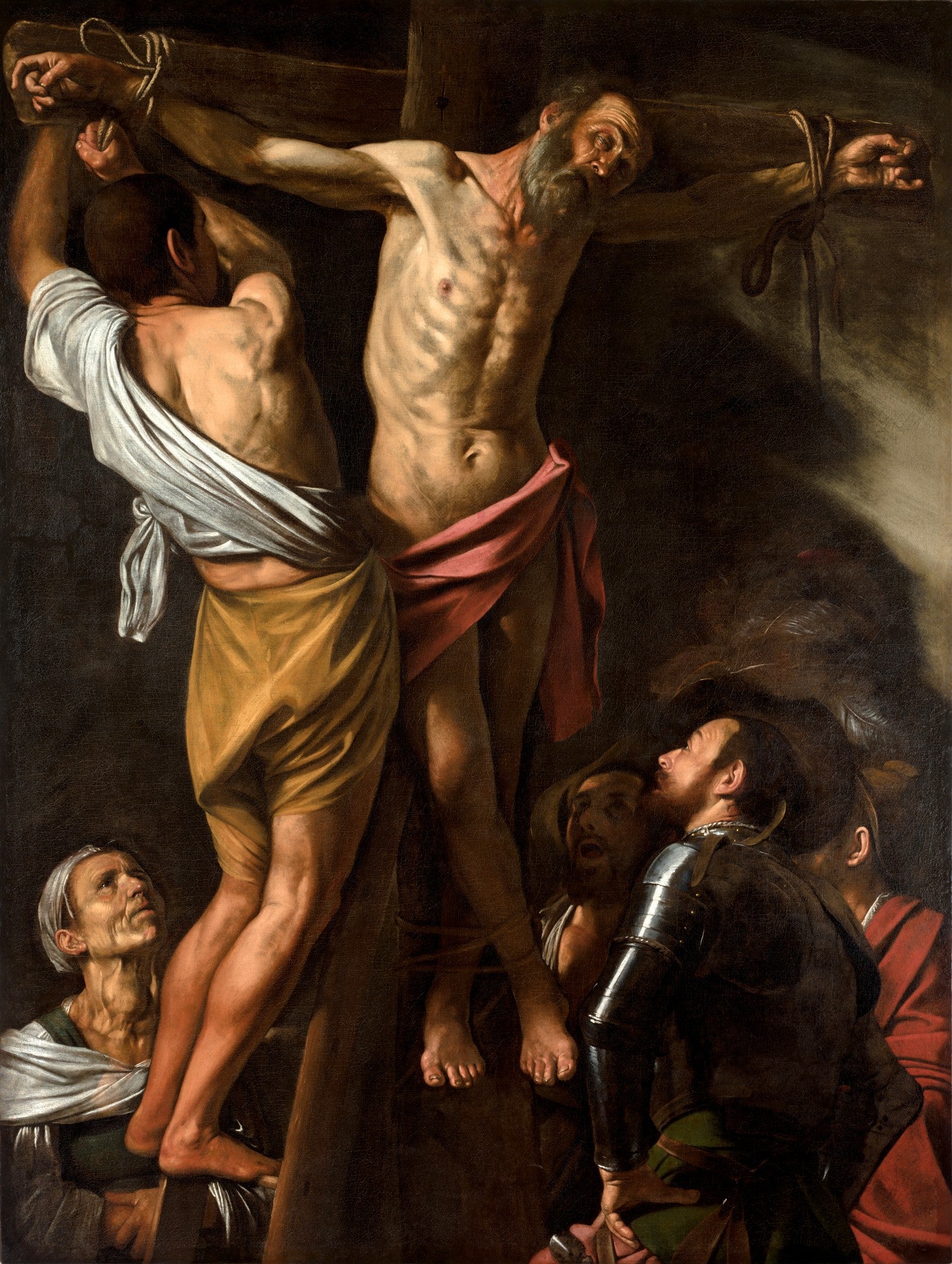 Pintura a óleo de Caravaggio, 'A Crucificação de São Pedro', mostrando São Pedro crucificado de cabeça para baixo por três homens, com expressões intensas e iluminação dramática.