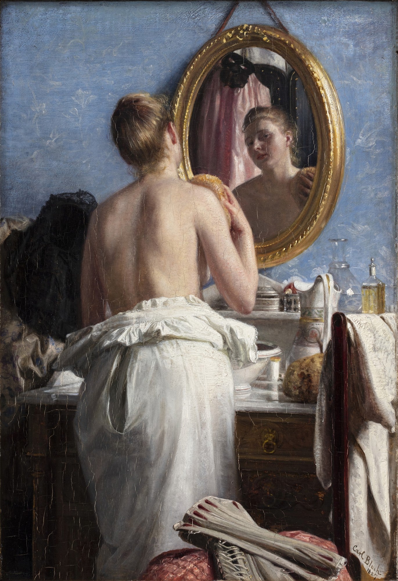 Quadro decorativo com pintura a óleo de Carl Bloch, 'A Mulher no Espelho'. Retrata uma mulher de costas, seminu, olhando seu reflexo em um espelho oval dourado, em um ambiente íntimo.