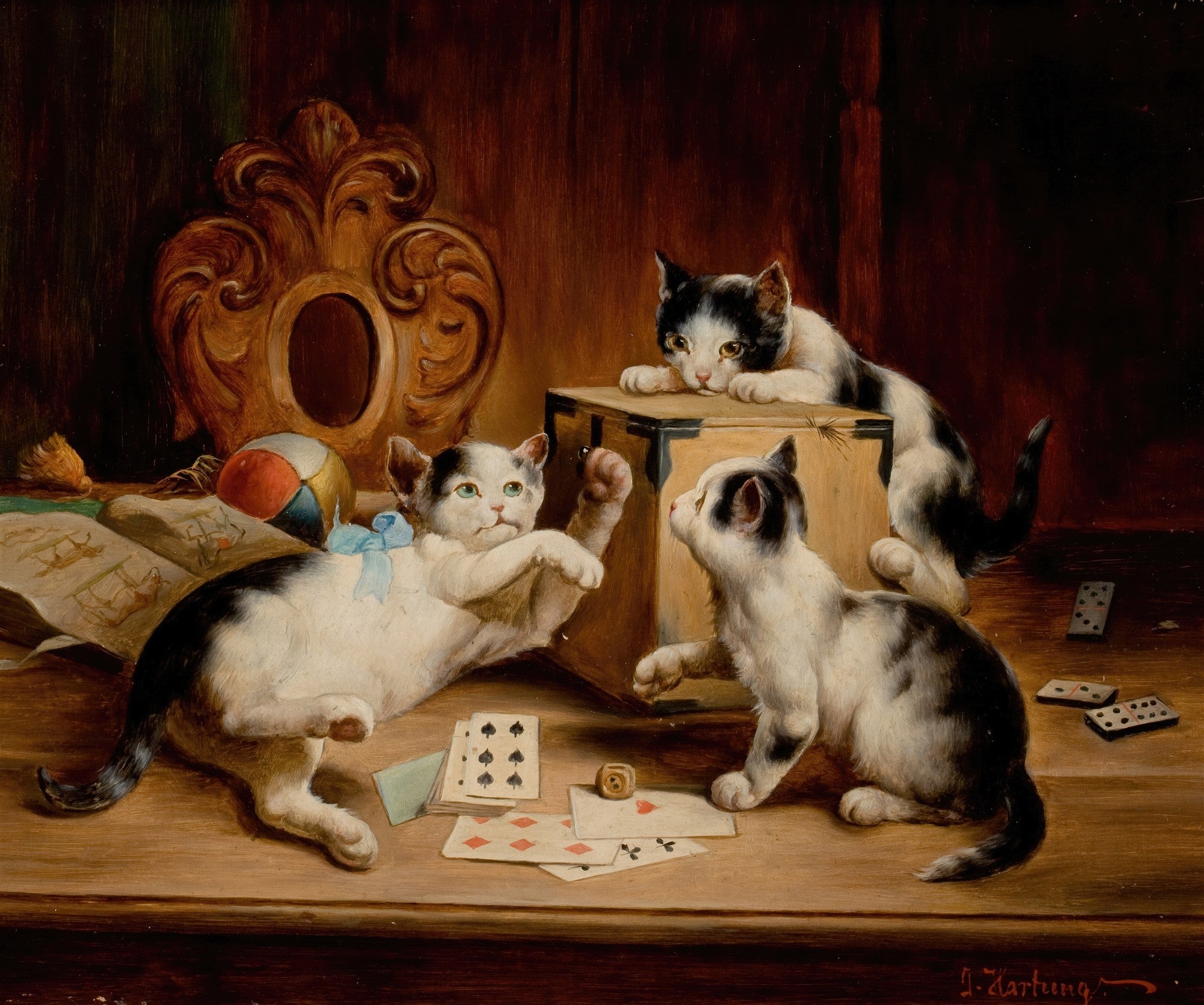Quadro decorativo mostrando três gatinhos preto e branco brincando com cartas de baralho e um dado em uma mesa de madeira, com um objeto ornamental dourado e um livro ao fundo. A obra é atribuída a Carl Reichert.