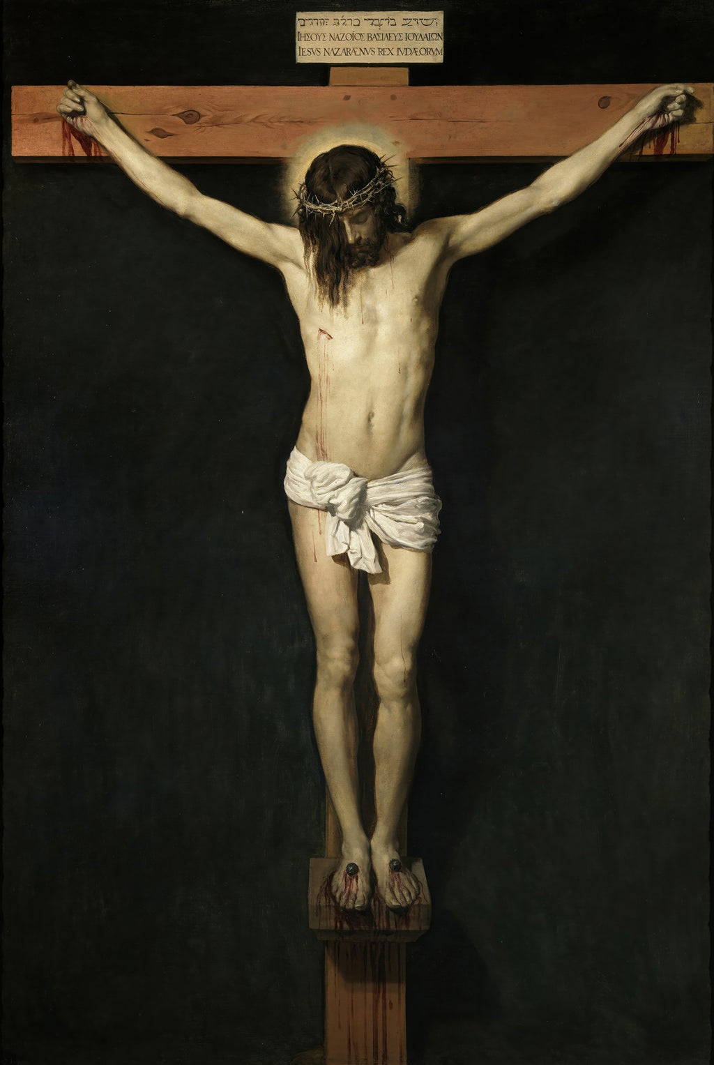 Quadro decorativo com a obra Cristo Crucificado de Diego Velázquez, mostrando Jesus na cruz com um pano branco e fundo escuro. A imagem é detalhada e transmite serenidade e dor.