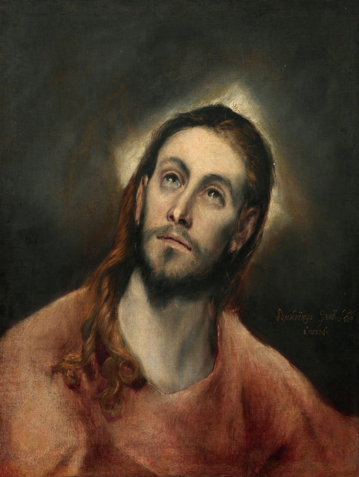 Quadro decorativo com a obra 'Cristo Redentor' de El Greco, retratando o busto de Jesus Cristo com cabelos longos e barba, olhando para cima com uma auréola suave ao redor da cabeça, em um fundo escuro.