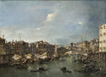 Pintura a óleo de Francesco Guardi, O Grande Canal com a Ponte de Rialto. Representa o Grande Canal de Veneza com barcos e gôndolas, e a Ponte de Rialto ao fundo sob um céu nublado. As margens são ladeadas por edifícios históricos.