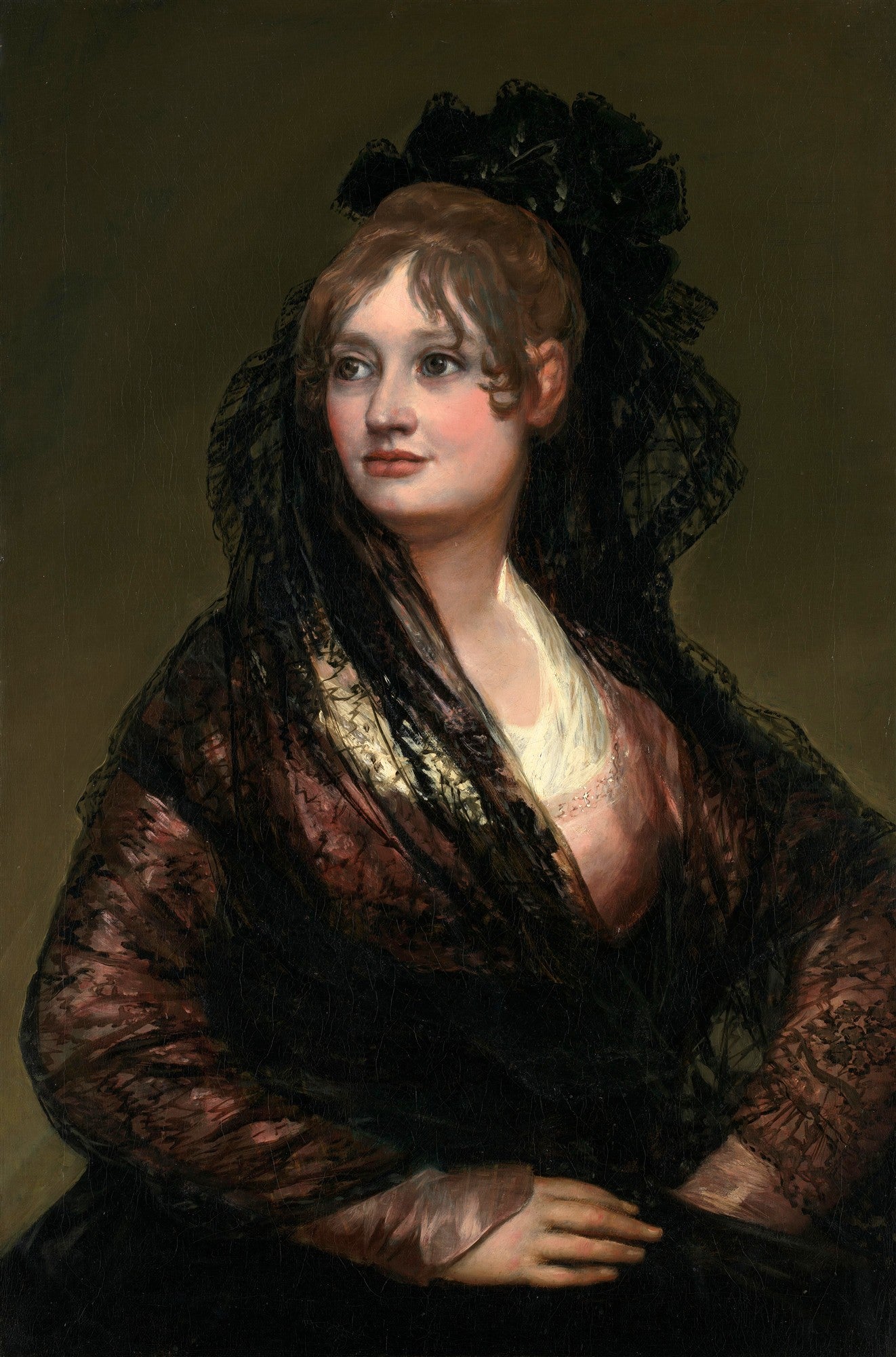 Retrato de uma jovem dama com cabelos castanhos e vestindo um xale de renda preta, com um olhar pensativo e sereno, em fundo escuro. Obra atribuída a Francisco de Goya.
