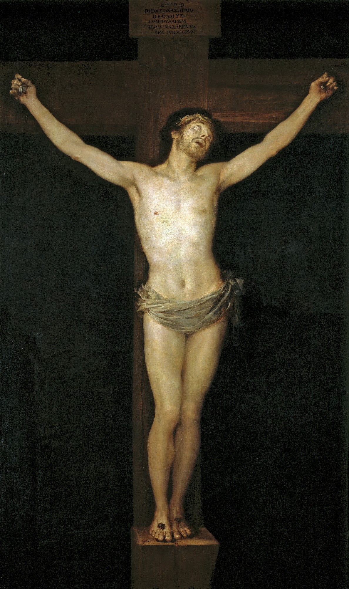Quadro decorativo mostrando a obra 'Cristo Crucificado' de Francisco de Goya. Jesus Cristo está pregado na cruz, com os braços estendidos e o corpo pálido contra um fundo escuro. Uma coroa de espinhos na cabeça e um pano cobrindo a cintura.