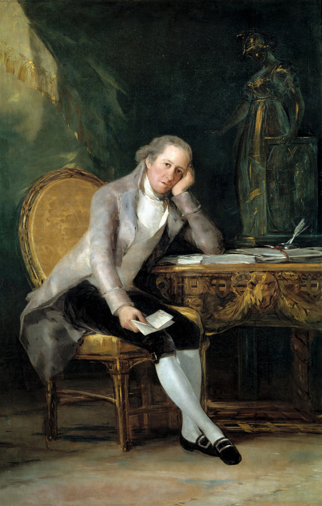 Retrato de Jovellanos, pintado por Francisco de Goya, mostrando um homem sentado com expressão pensativa, apoiando o rosto na mão. Ele veste roupas de época e está em um ambiente escuro com uma estátua e uma mesa detalhada ao fundo.