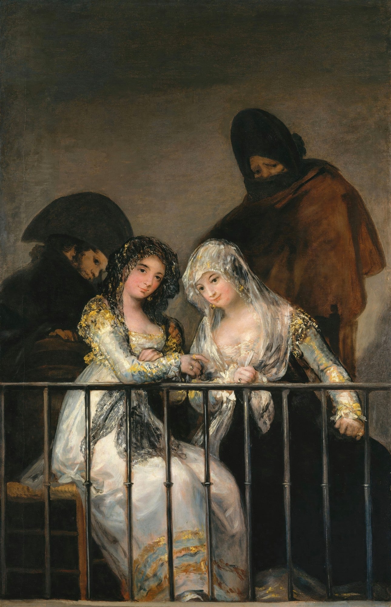 Quadro decorativo "O Balcão" de Francisco de Goya, mostrando duas mulheres ricamente vestidas em um balcão, observadas por duas figuras masculinas sombrias ao fundo, com cores escuras e expressivas.