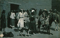 Quadro de Frederic Remington 'San Carlos' retratando um grupo de figuras, possivelmente nativos americanos, alguns a pé, outros com animais como cavalos e burros, em um cenário de construções de pedra sob uma luz crepuscular azulada.