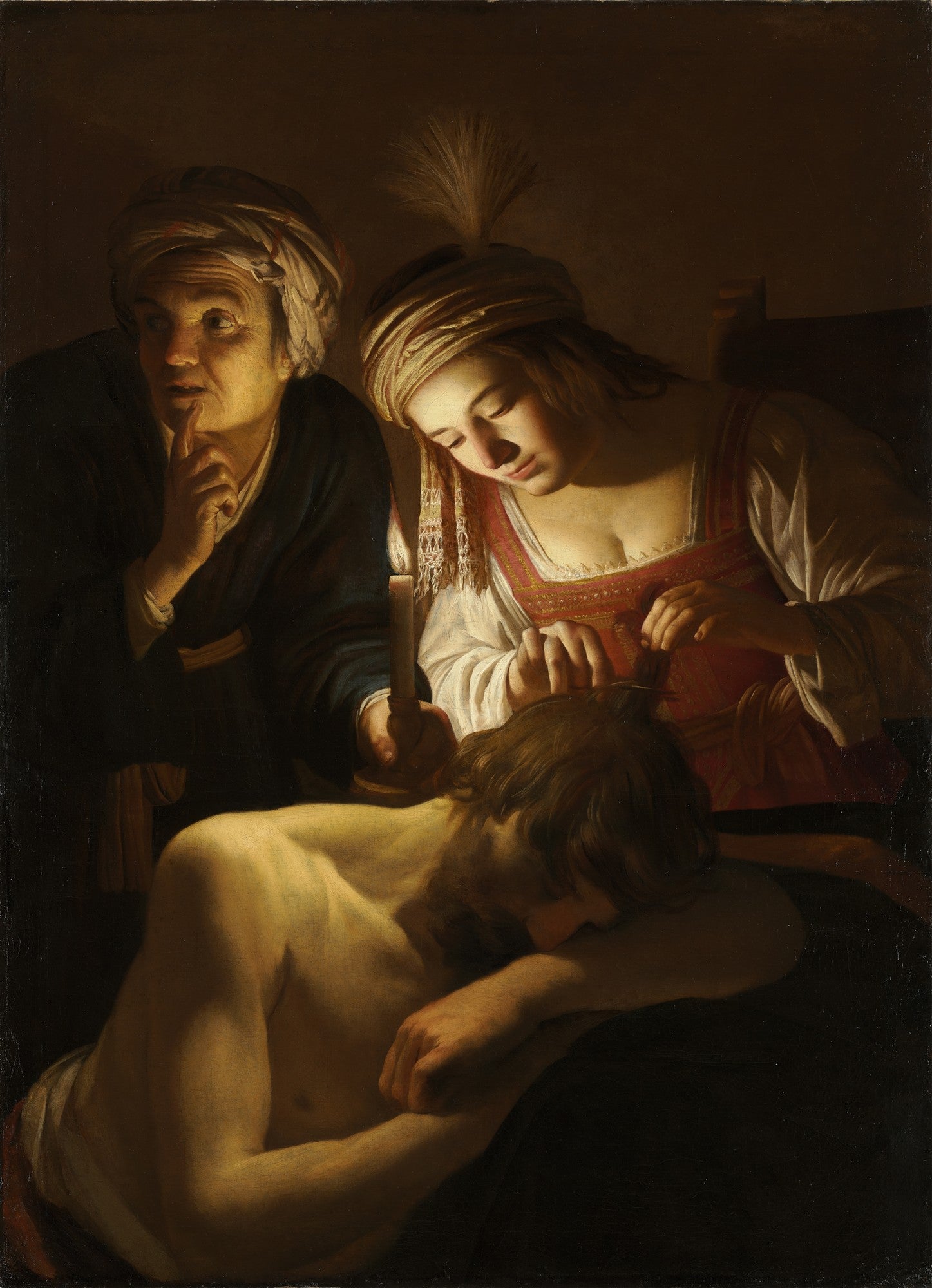 Quadro decorativo 'Sansão e Dalila' de Gerard van Honthorst, mostrando Dalila cortando o cabelo de Sansão adormecido, sob a luz de uma vela, com uma figura mais velha observando.