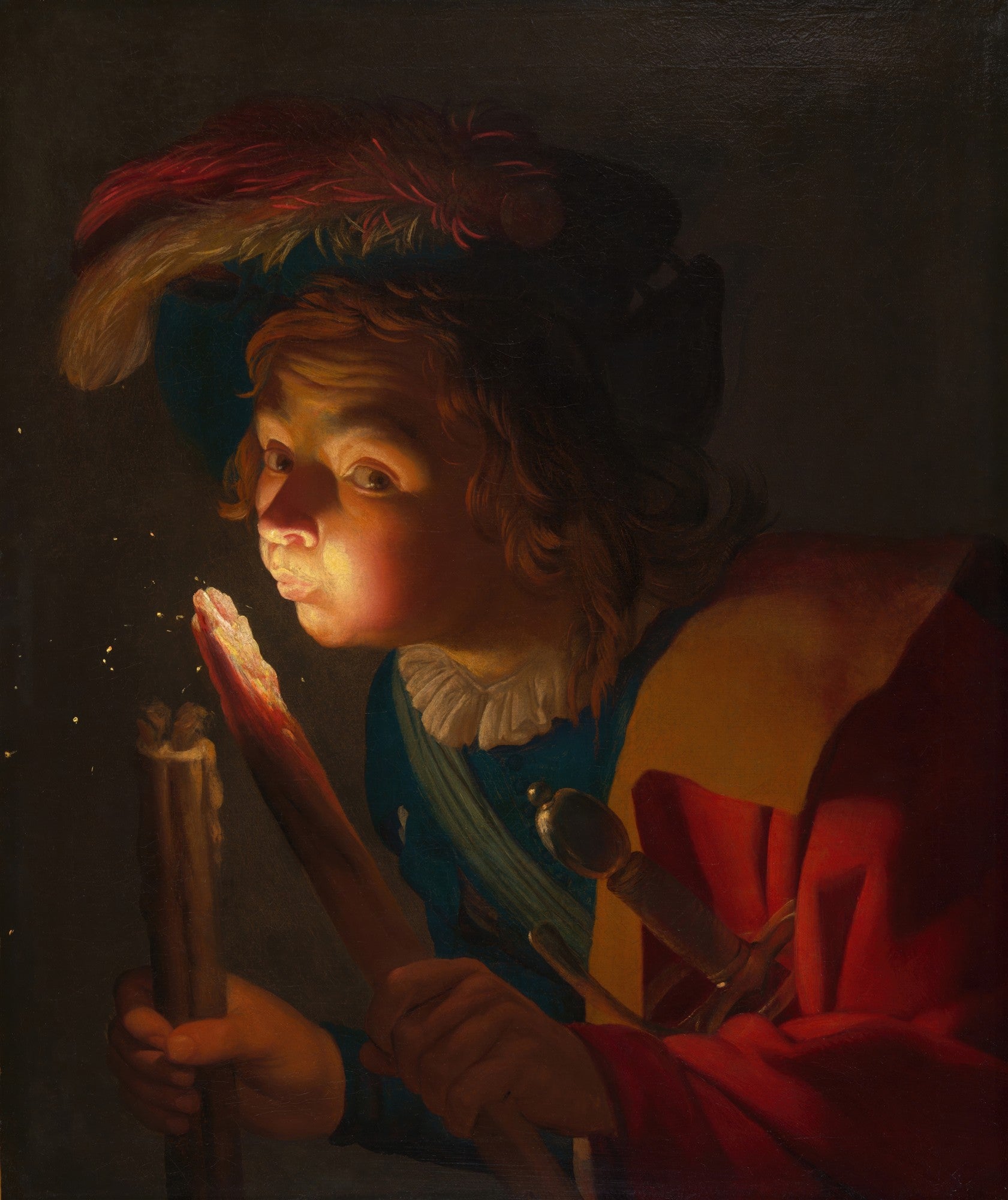 Quadro decorativo com um jovem em vestes coloridas, com um chapéu emplumado, soprando uma brasa que emite luz e faíscas. A cena é escura, destacando o rosto iluminado do jovem e a brasa em suas mãos.