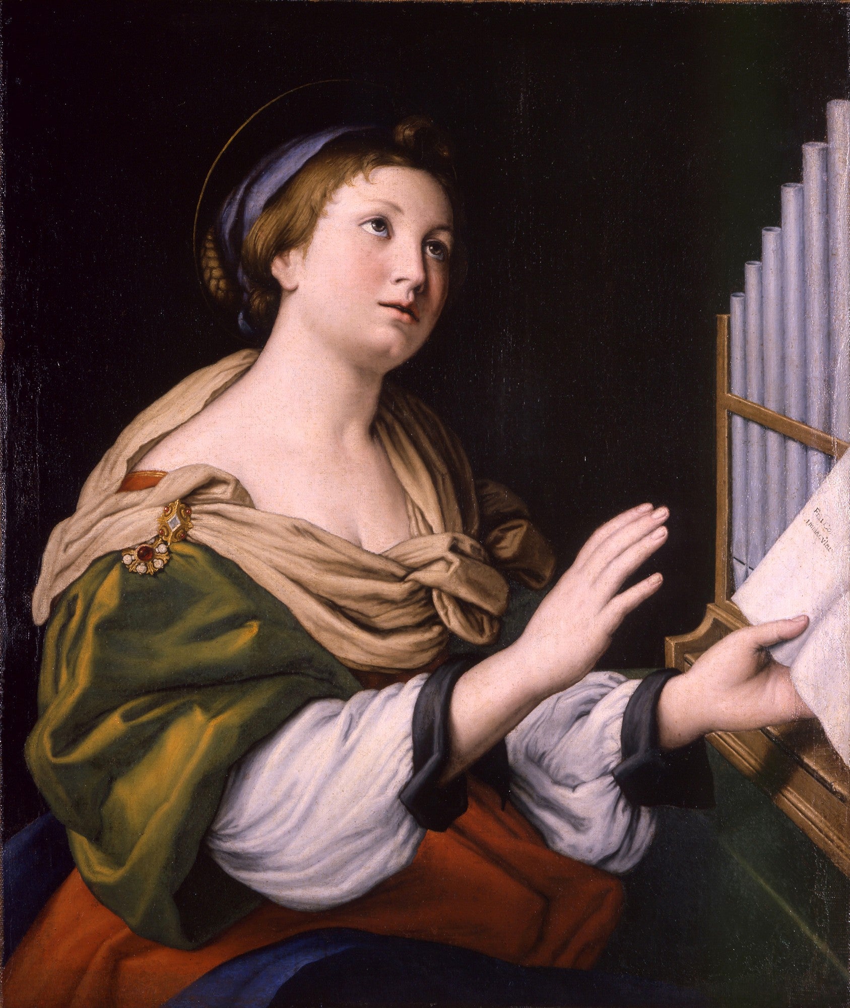 Santa Cecília, obra de Giovanni Battista Sassoferrato, com a santa em vestes clássicas olhando para cima, com um órgão ao seu lado e partitura nas mãos. Ela tem um halo dourado sobre a cabeça.