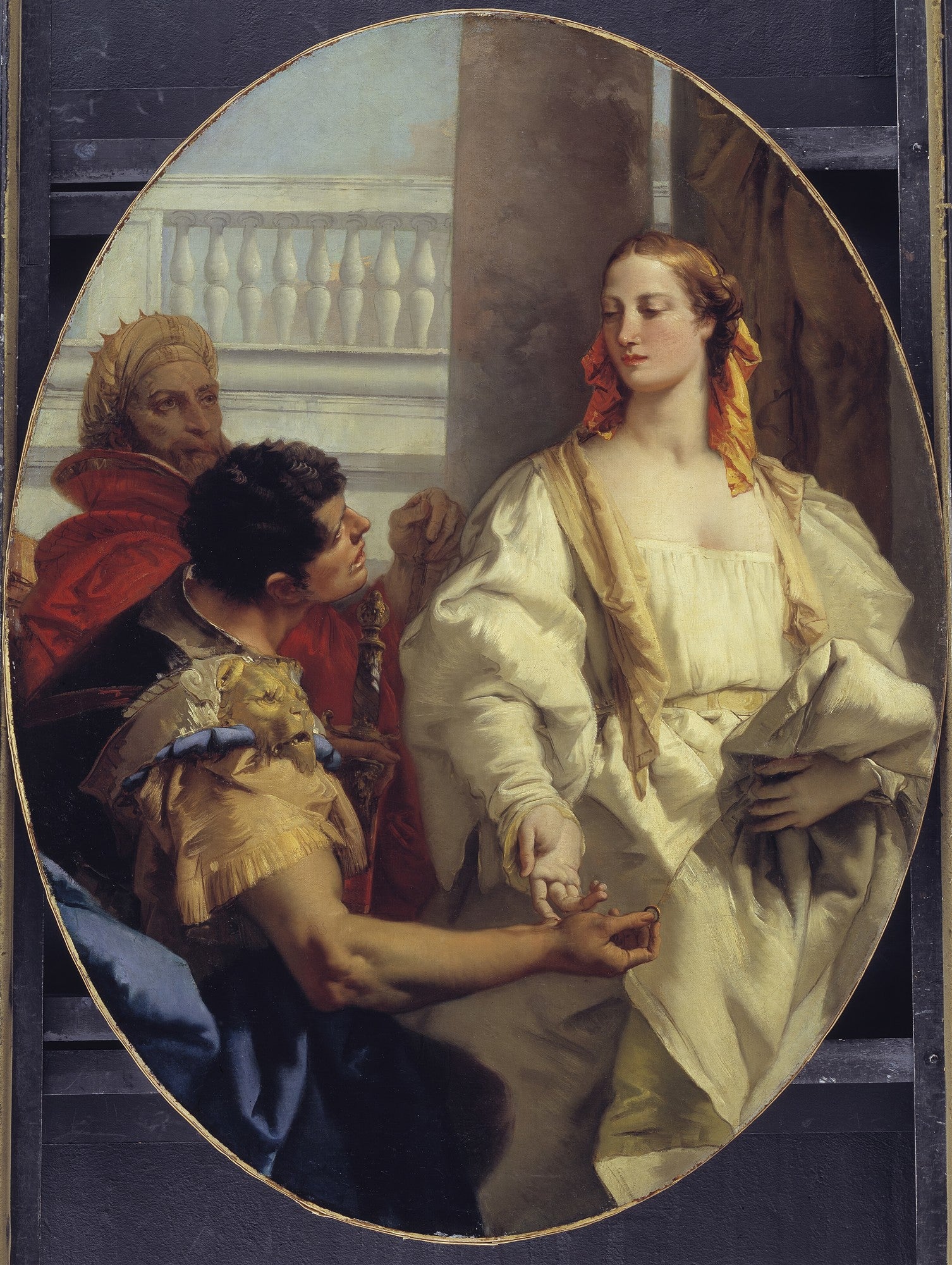 Quadro oval com cena barroca de um homem oferecendo um anel a uma mulher, com outra figura masculina ao fundo. As cores são ricas e os tecidos detalhados.