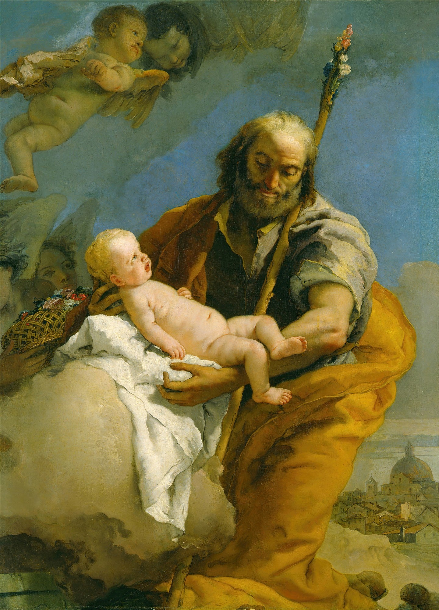 Pintura a óleo de Giovanni Battista Tiepolo mostrando São José segurando o Menino Jesus, com anjos e querubins flutuando ao redor em um céu azul. São José tem barba e veste túnica amarela e marrom, com um bastão florido. O Menino Jesus é um bebê nu com cabelos loiros. A cena é celestial, com nuvens brancas e uma cidade ao fundo.