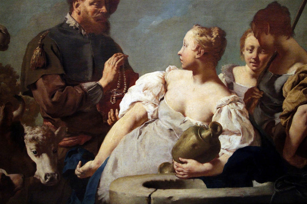 Quadro decorativo "A Oferta de Rebeca" de Giovanni Battista Piazzetta. A cena mostra Rebeca com um jarro, olhando para um homem que lhe oferece um colar de pérolas, enquanto outras figuras e um bezerro observam ao fundo. A iluminação é dramática, destacando os rostos e as pérolas.