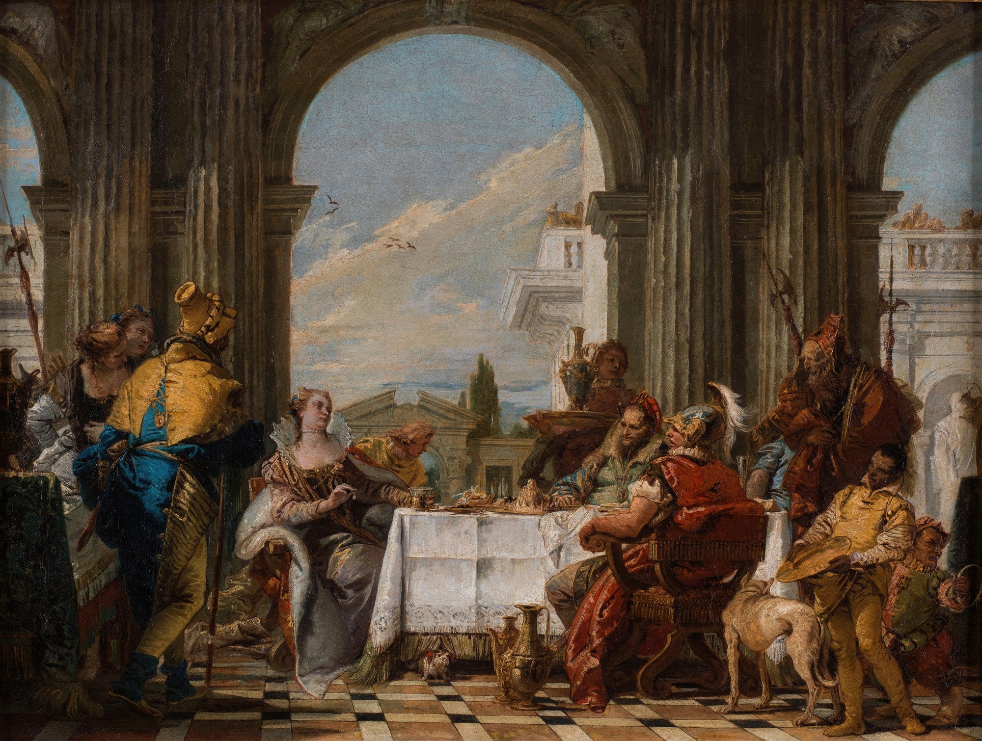 Quadro decorativo detalhando um banquete suntuoso com figuras históricas ou mitológicas em um cenário arquitetônico clássico, atribuído a Giovanni Battista Tiepolo. Cores vibrantes e dramáticas, com personagens ricamente vestidos e um cachorro aos pés de um dos convidados.