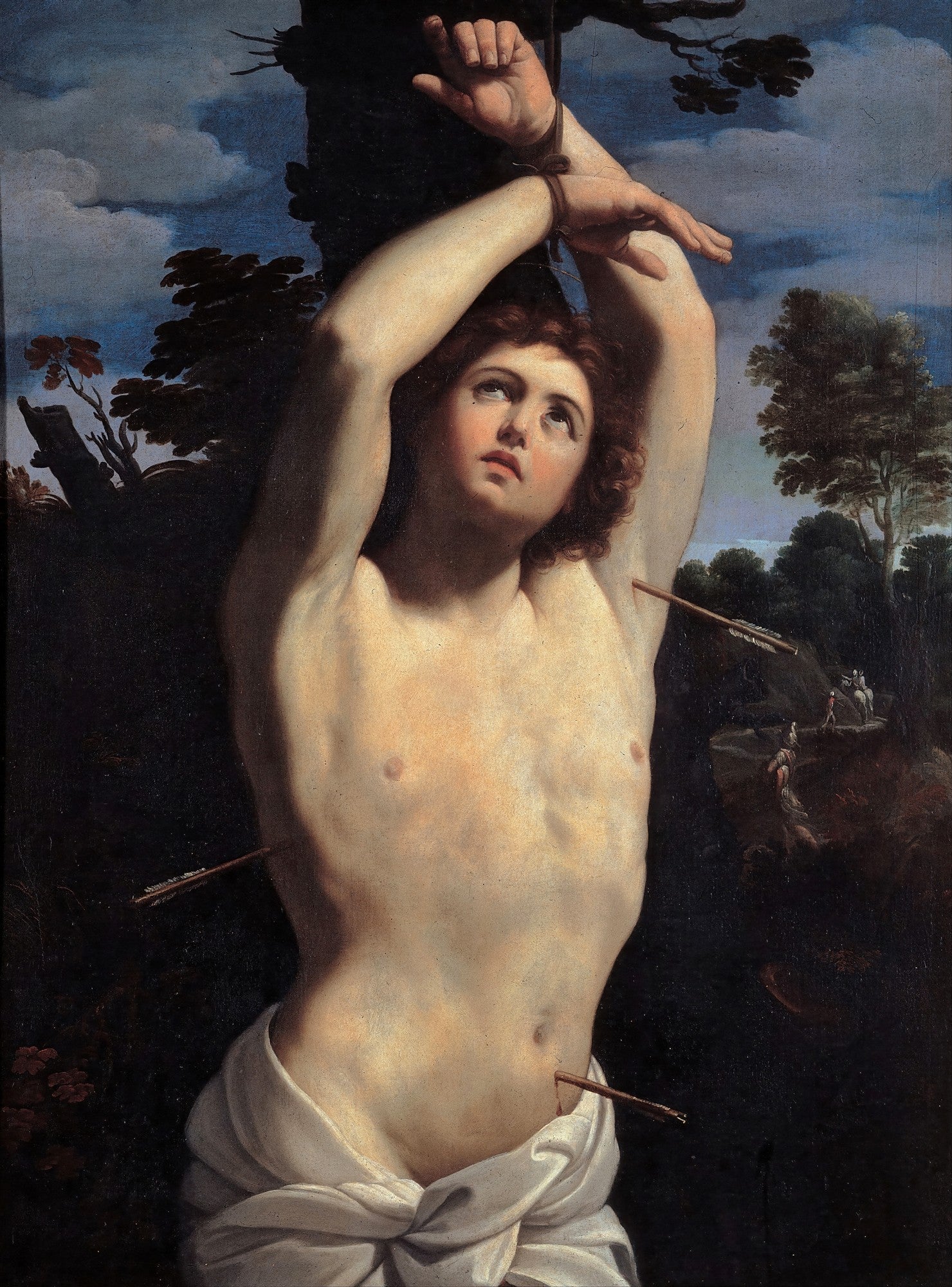 Pintura a óleo de São Sebastião, de Guido Reni, mostrando o santo amarrado a uma árvore, com flechas em seu corpo, olhando para o céu com uma expressão serena. A imagem exibe um corpo musculoso iluminado por uma luz dramática, com um fundo escuro e paisagem ao longe.