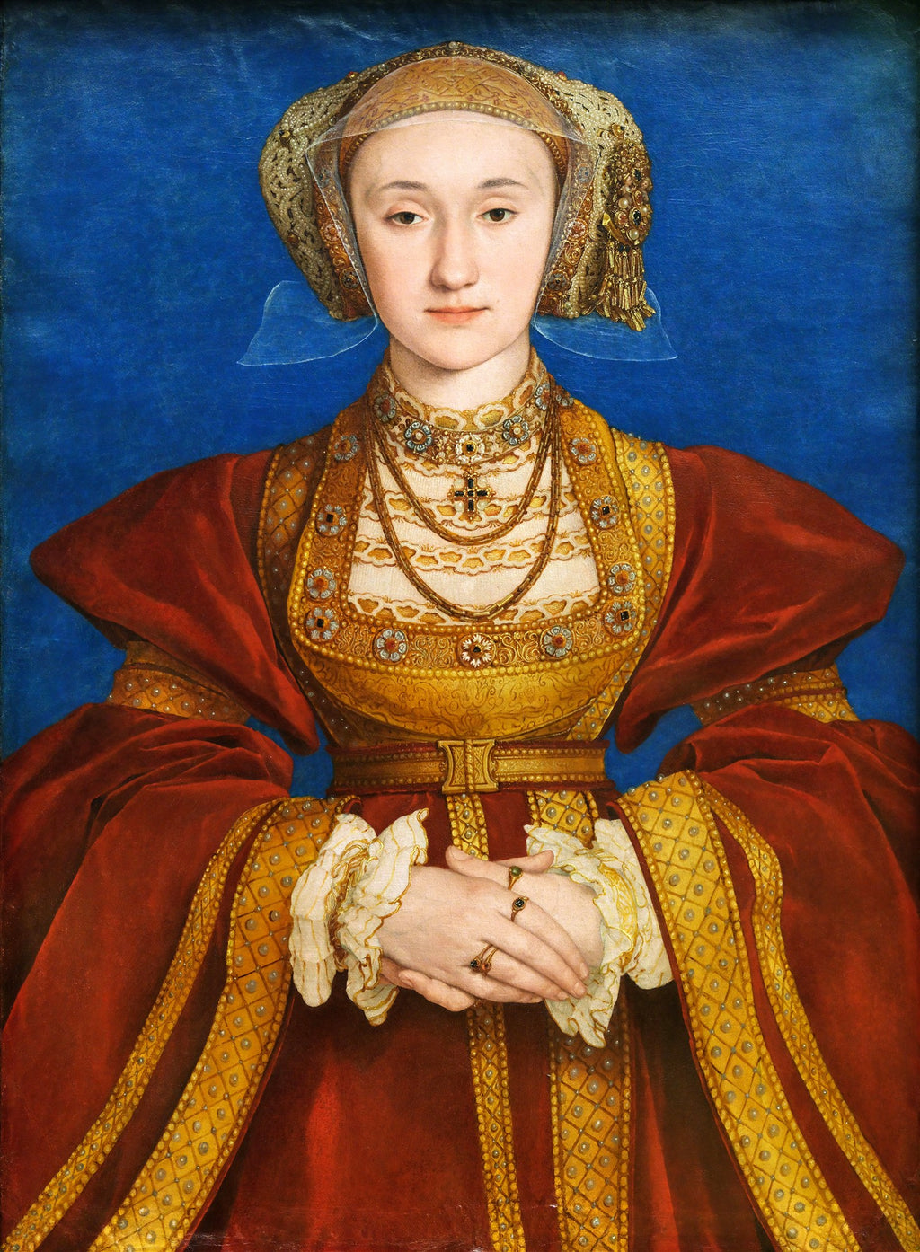 Retrato de Ana de Cleves por Hans Holbein, o Jovem. A imagem mostra uma mulher jovem com touca dourada e véu transparente, vestindo um vestido suntuoso em tons de vermelho e dourado, com joias elaboradas, contra um fundo azul sólido. Suas mãos estão elegantemente cruzadas à frente.