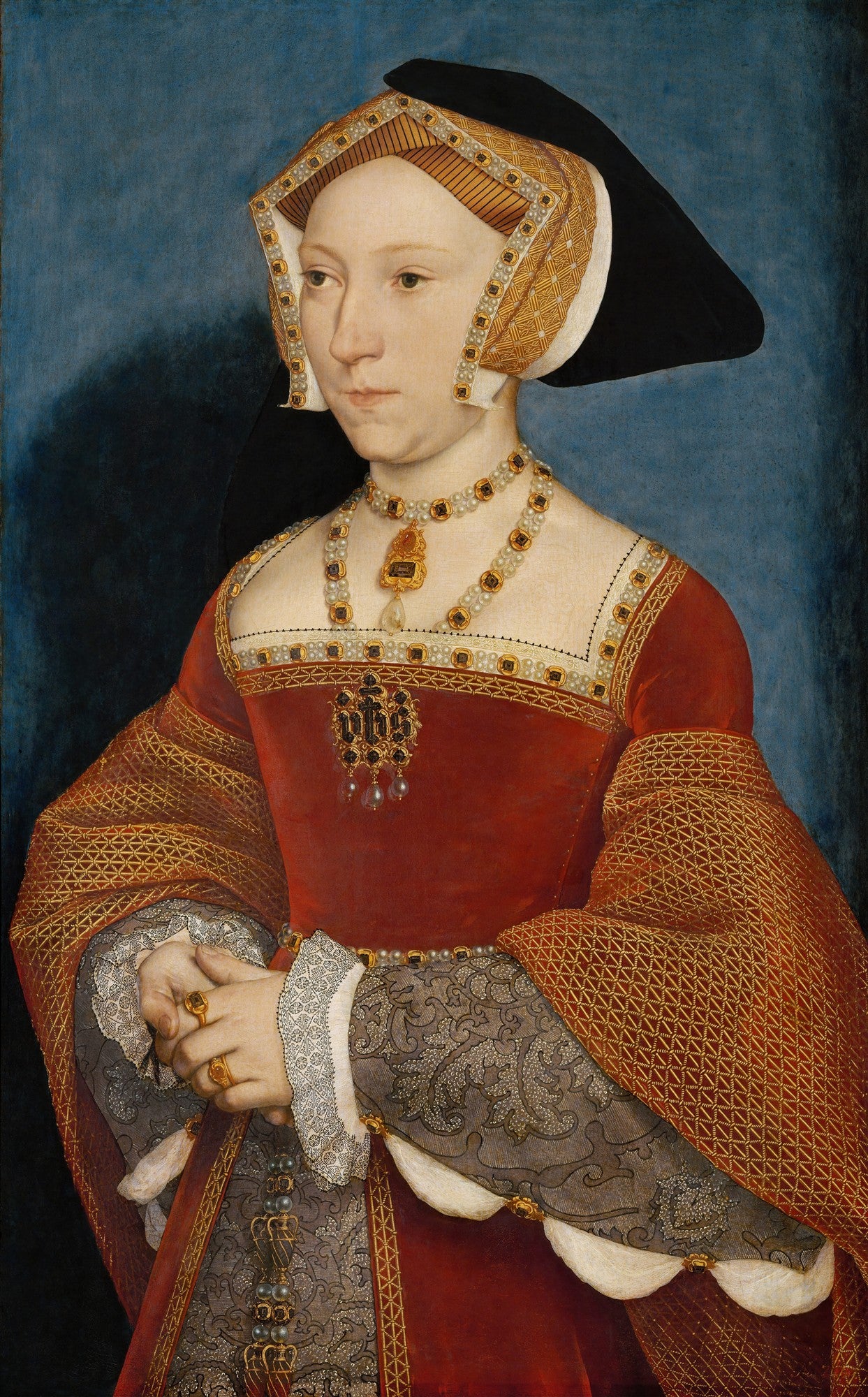 Retrato de Jane Seymour pintado por Hans Holbein, o Jovem, mostrando uma mulher com touca elaborada, vestido vermelho rico em detalhes e joias, com as mãos cruzadas e um fundo azul escuro.