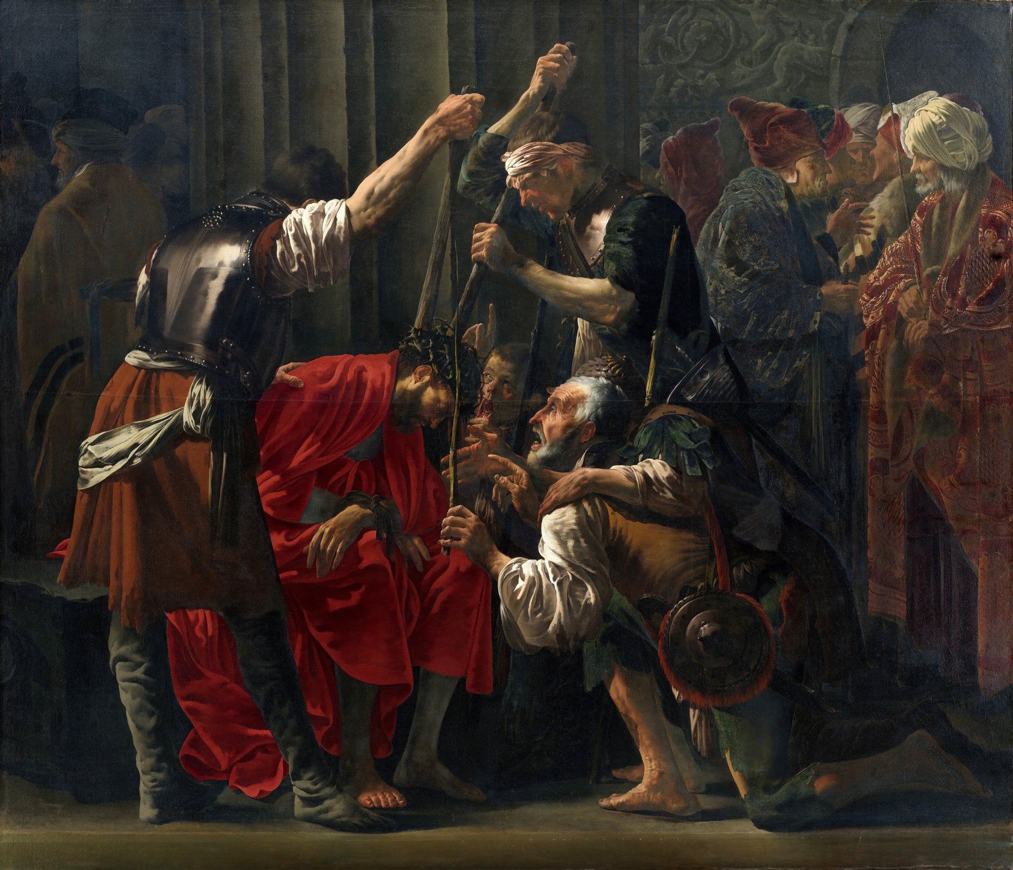 Quadro decorativo mostrando a cena bíblica da Coroação de Espinhos, com figuras em vestes antigas em tons escuros e terrosos, e um homem de túnica vermelha no centro sendo pressionado com espinhos na cabeça por outros homens. A luz dramática realça os rostos e as expressões de dor e escárnio.