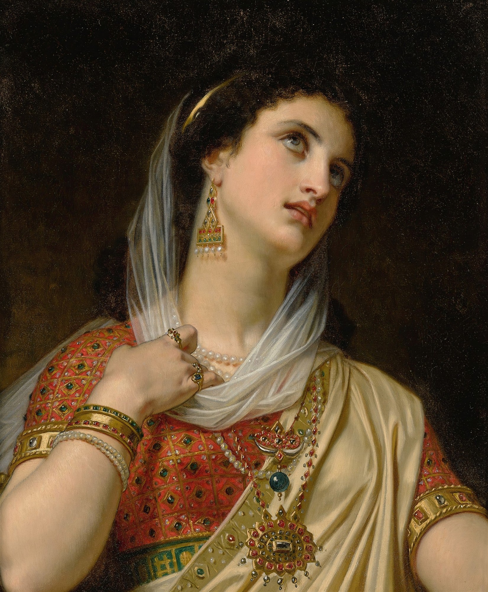 Retrato de uma mulher jovem, de pele clara e cabelos escuros, com um véu branco translúcido sobre a cabeça. Ela usa brincos pendentes elaborados, um colar de pérolas, braceletes e anéis, e um vestido vermelho com detalhes dourados e um manto bege. A expressão é de introspecção, com os olhos azuis levemente erguidos para cima, sobre um fundo escuro. A imagem é uma pintura a óleo de Hugues Merle.