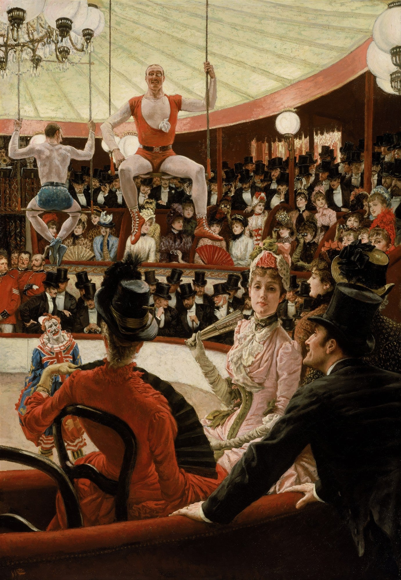 Pintura de James Tissot mostrando um circo com trapezistas no alto e uma plateia elegante vestida com roupas de época. Mulheres com chapéus elaborados e homens de cartola assistem ao espetáculo, enquanto um palhaço aparece em primeiro plano à esquerda. A cena é iluminada por lustres e reflete a vida social do século XIX.