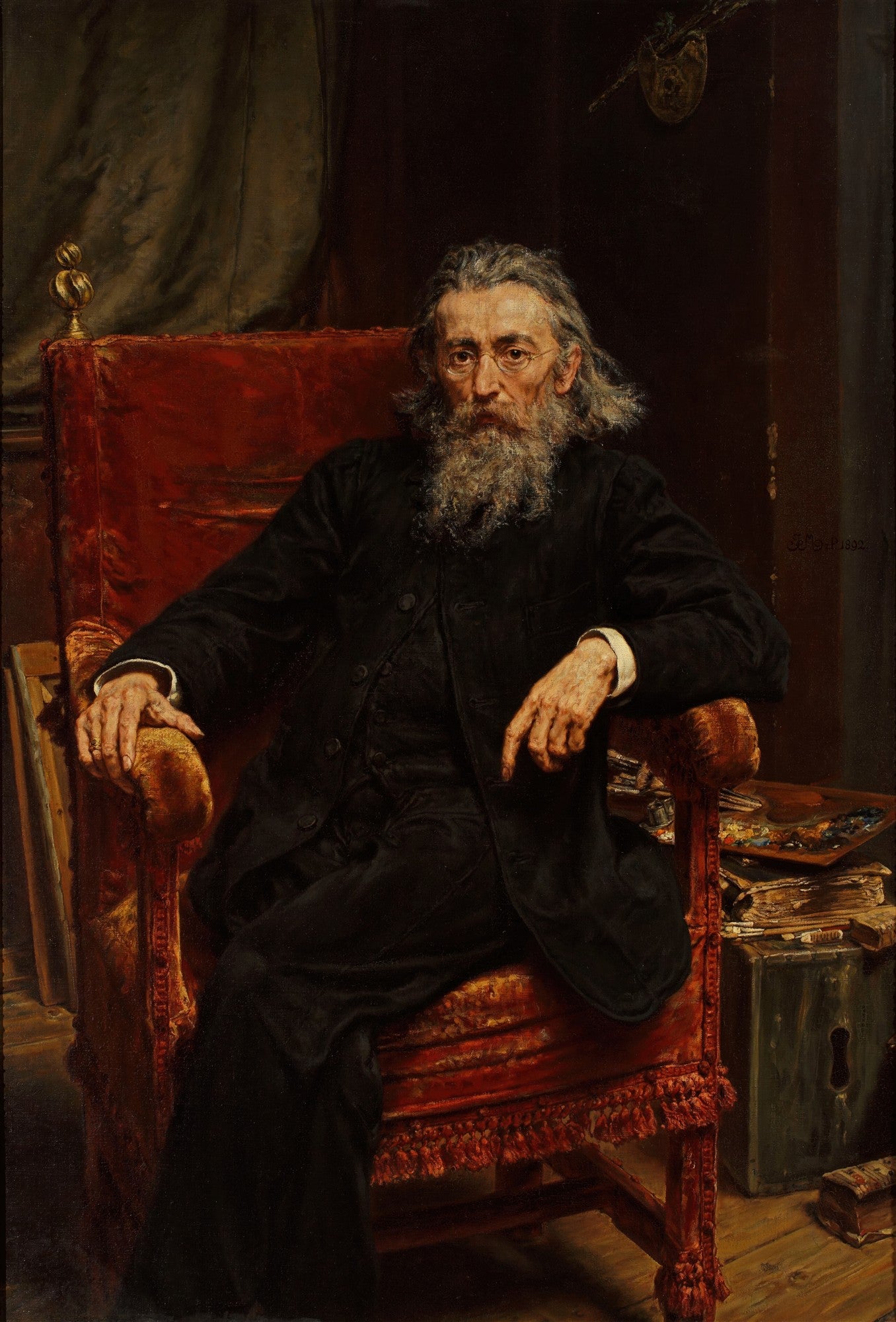 Quadro decorativo com retrato de um homem idoso com barba longa e grisalha, sentado em uma poltrona vermelha, obra de Jan Matejko.