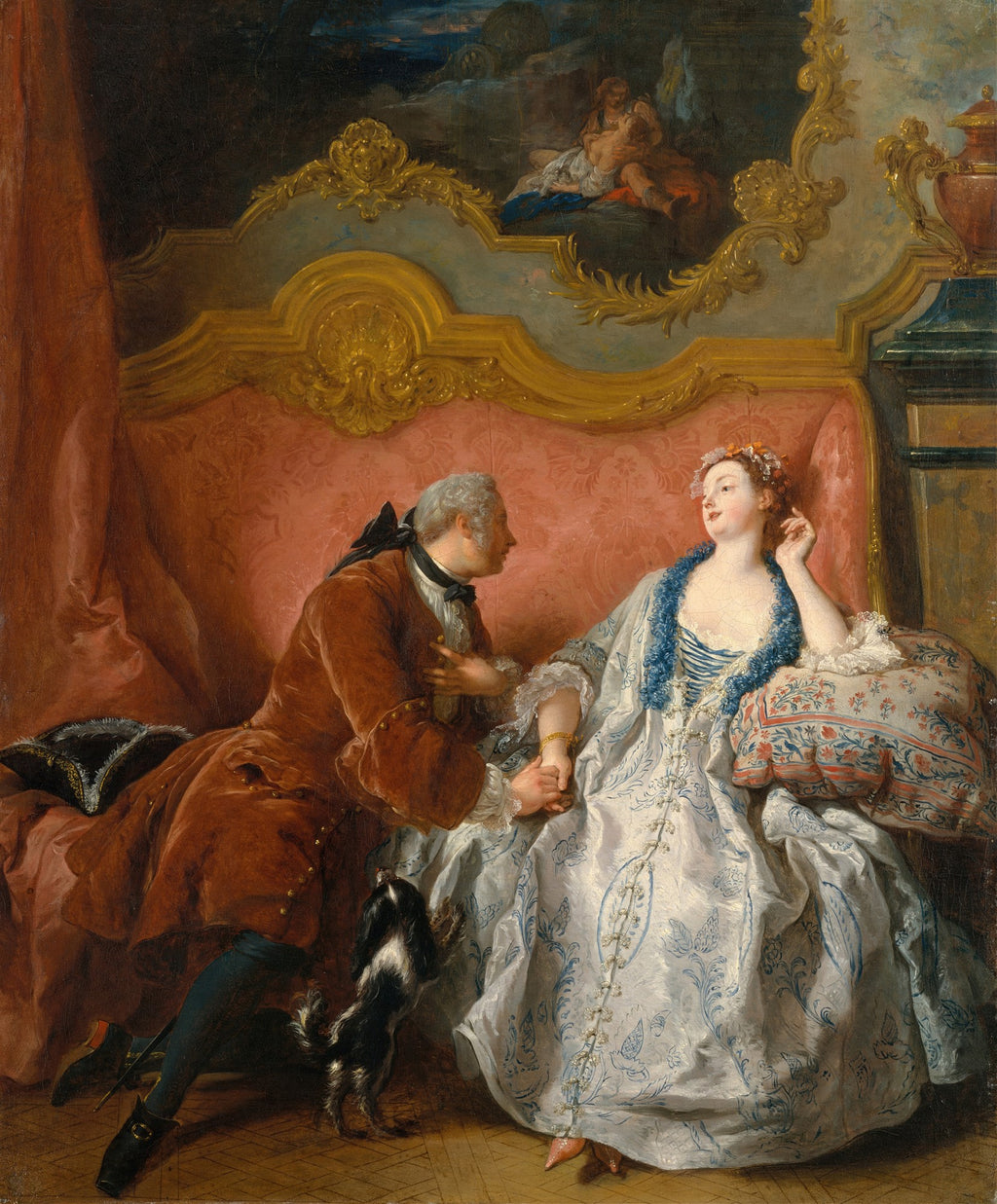 Quadro decorativo 'A Leitura' de Jean François de Troy, mostrando um casal do século XVIII em um interior luxuoso, com o homem ajoelhado segurando a mão da mulher enquanto um cãozinho os observa, e uma cama ornamentada ao fundo.
