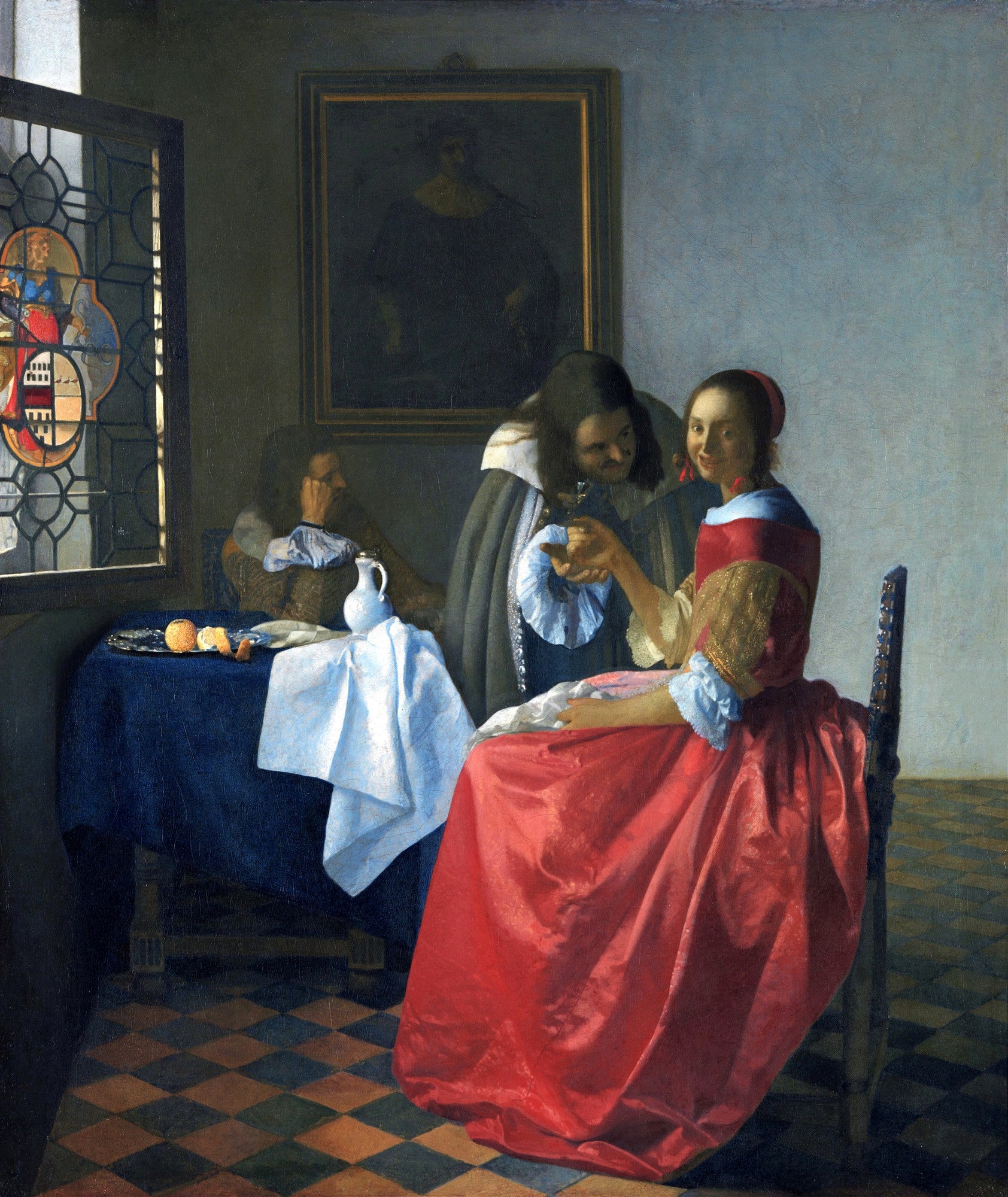 Quadro 'A Taça de Vinho' de Johannes Vermeer, retratando três figuras em um ambiente interno, com uma mulher de vestido vermelho no centro recebendo uma taça de vinho de um homem, enquanto outro observa ao fundo. A luz entra por uma janela vitral à esquerda.