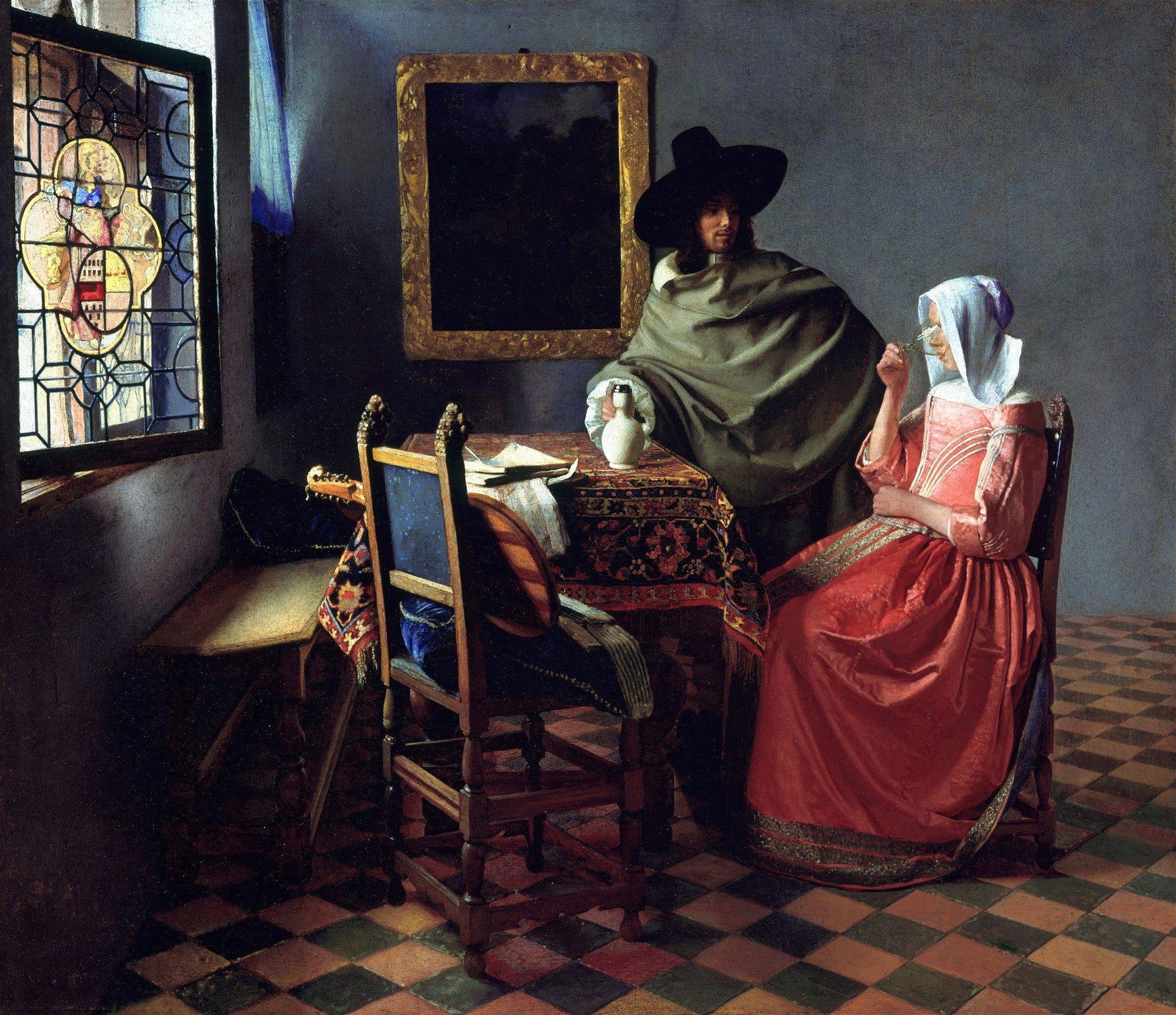 Quadro decorativo de Johannes Vermeer, O Encontro, exibindo um homem de chapéu preto e capa verde e uma mulher de vestido vermelho, sentados à mesa em um interior com janela de vitral e chão quadriculado.