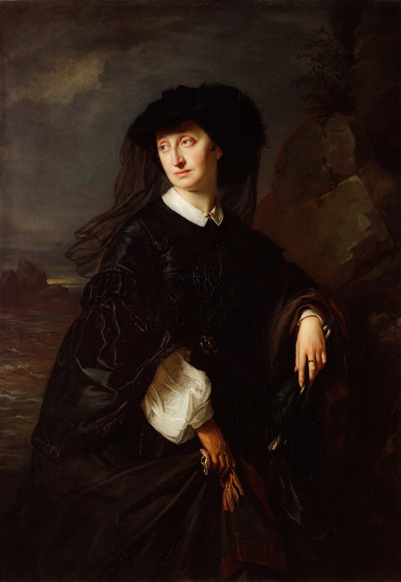 Retrato de uma mulher de meia-idade, vestida de preto com um chapéu grande e véu escuro, em um fundo dramático e rochoso. Atribuído a Józef Simmler.