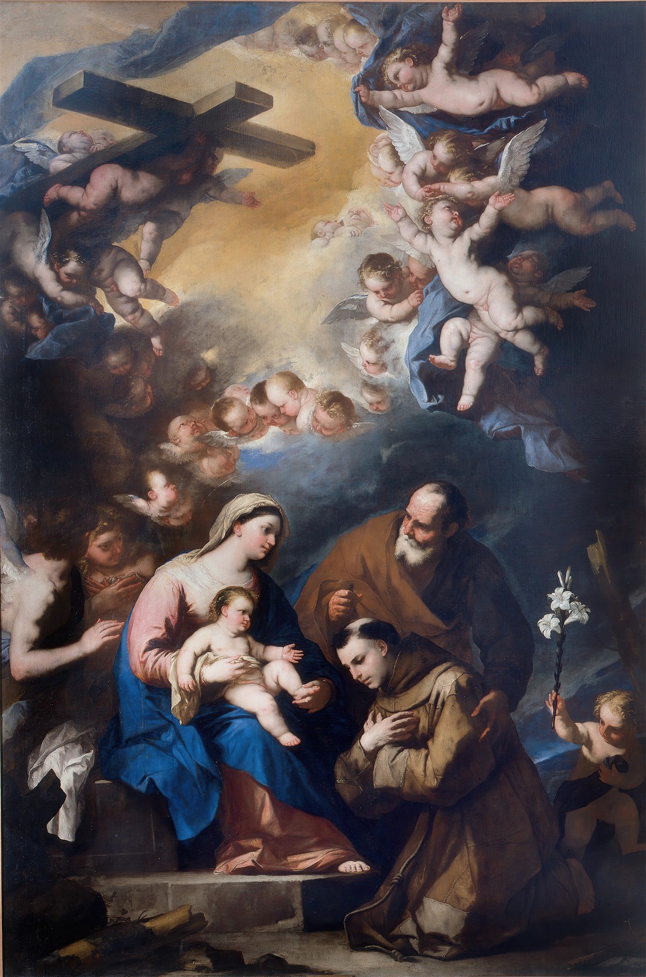 Pintura barroca que retrata a Sagrada Família com a Virgem Maria segurando o Menino Jesus, São José e Santo Antônio de Pádua ajoelhado, com uma multitude de anjos e querubins em nuvens no céu, e um anjo carregando uma cruz.