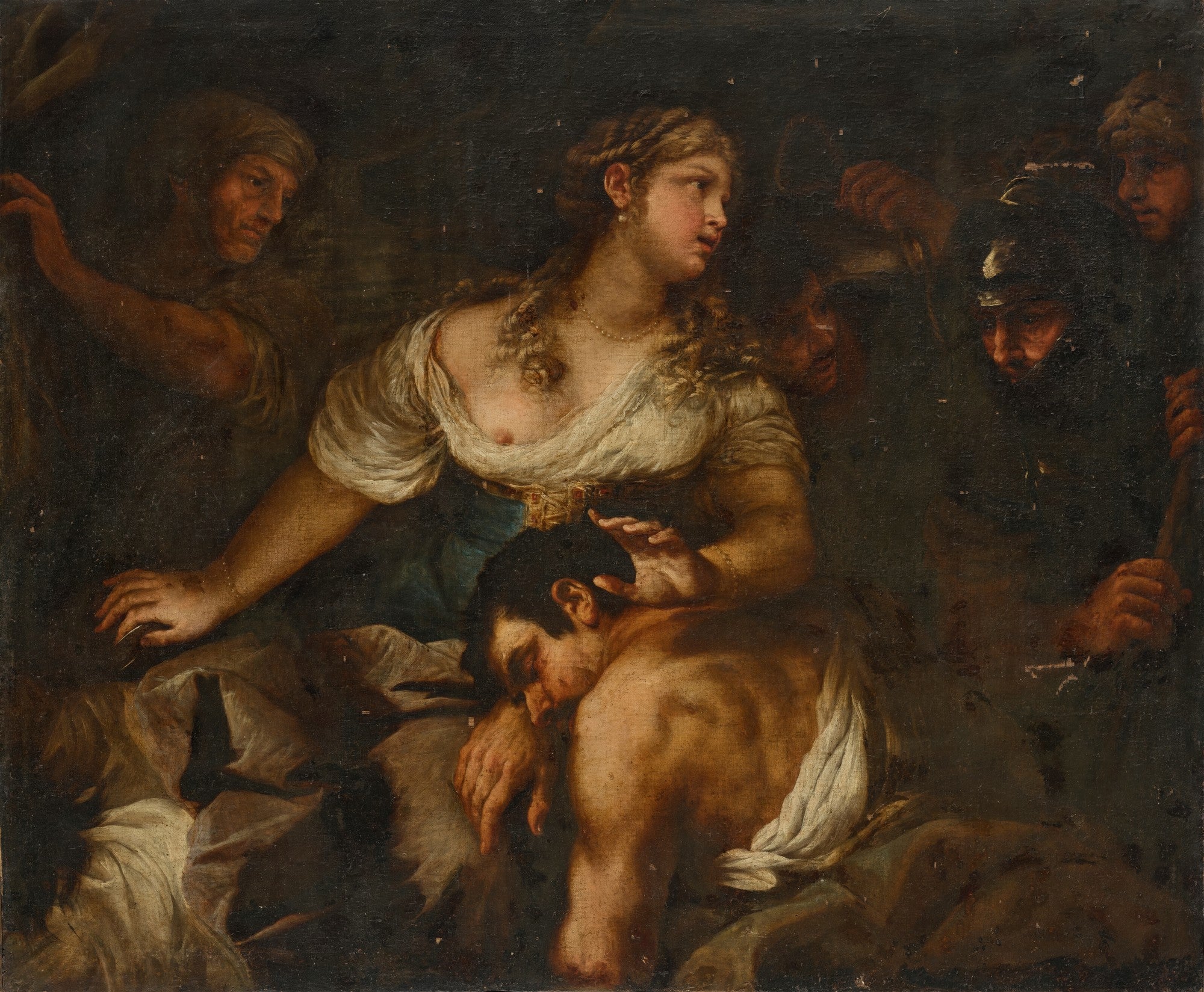 Pintura a óleo escura retratando uma mulher jovem de cabelos dourados e seios expostos segurando um homem adormecido em seu colo, enquanto figuras sombrias espreitam ao redor. A mulher tem uma expressão de apreensão, olhando para o lado, e o homem parece exausto ou inconsciente. A luz incide sobre a mulher e o homem, destacando o contraste dramático com o fundo escuro e as outras figuras.
