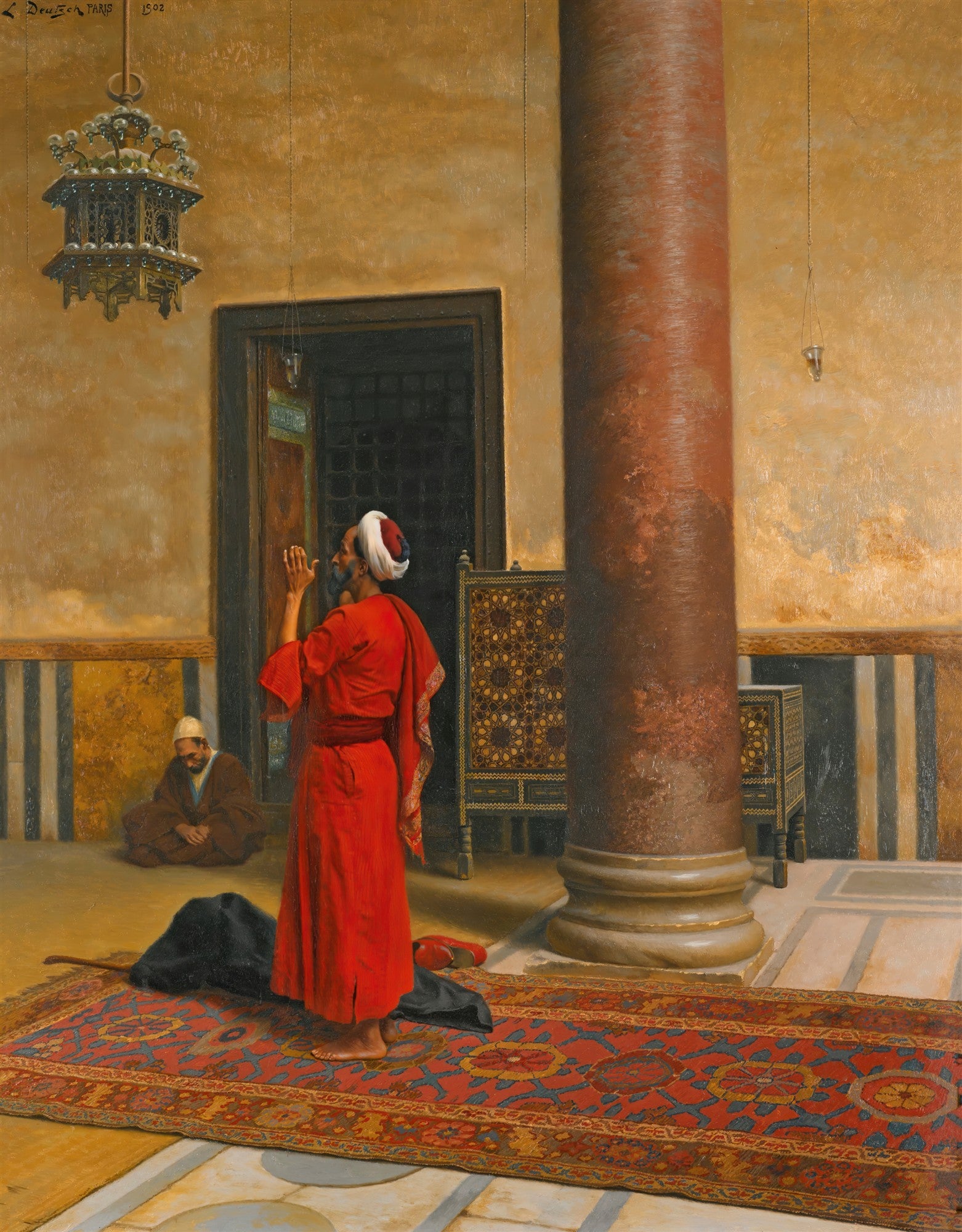 Pintura a óleo de Ludwig Deutsch, "A Oração", retratando um homem vestido de vermelho orando em um interior árabe com tapete persa e detalhes arquitetônicos dourados.