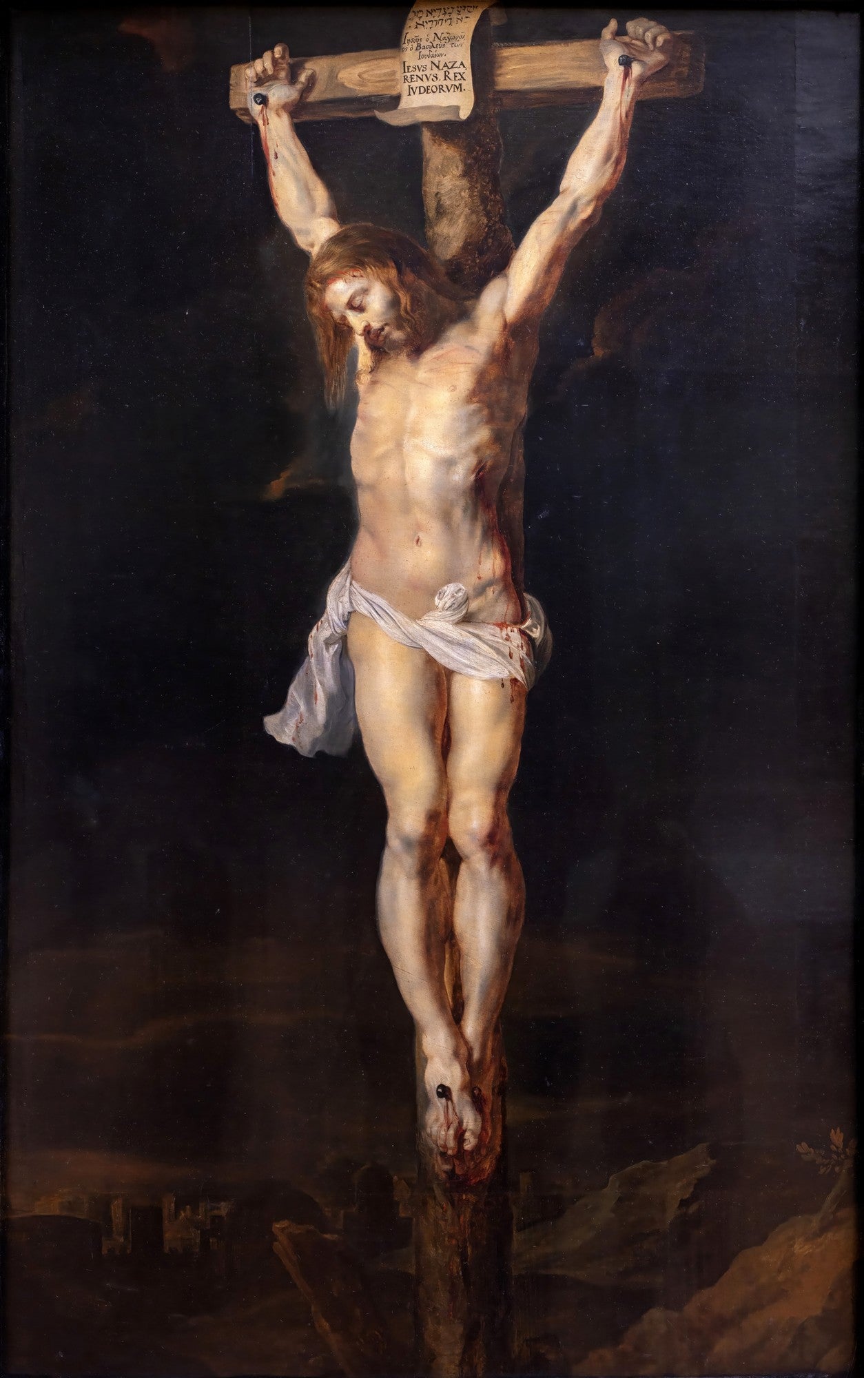 Quadro decorativo mostrando a crucificação de Cristo, com seu corpo pálido e musculoso na cruz, sobre um fundo escuro e dramático. A obra é de Peter Paul Rubens.