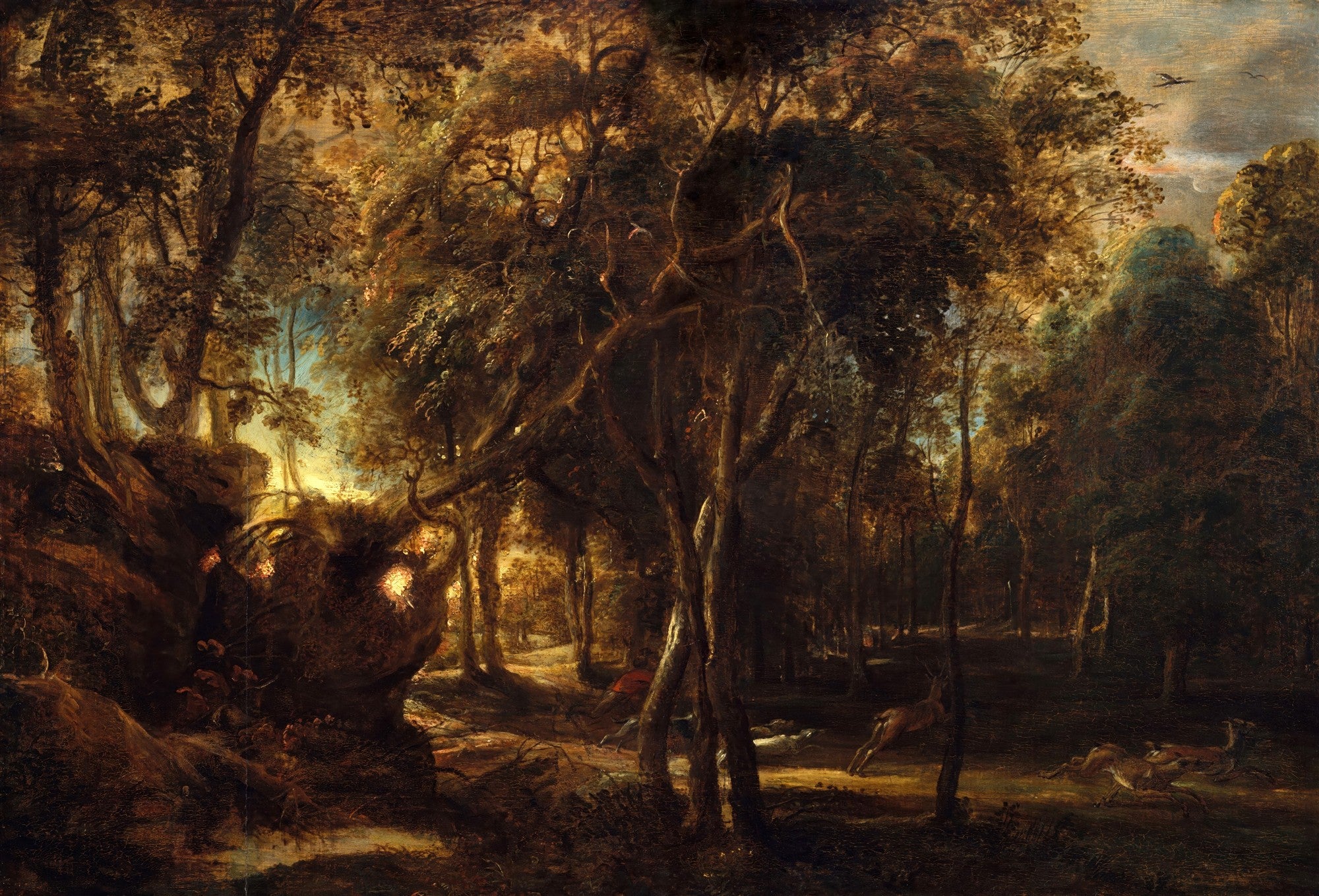 Quadro decorativo mostrando uma cena de caça em uma floresta escura e densa, com cervos em movimento e caçadores, atribuído a Peter Paul Rubens.