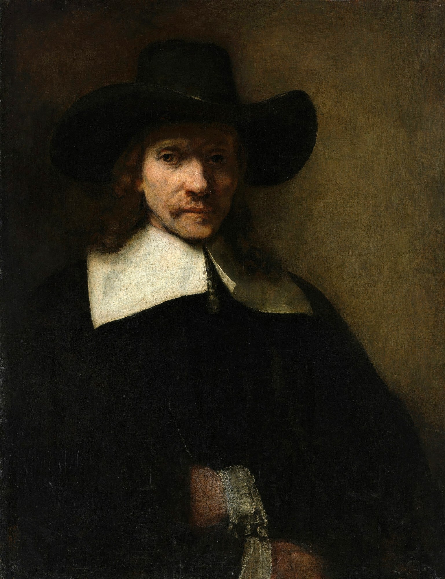 Retrato de um homem com bigode, cavanhaque e cabelos longos, usando um chapéu de abas largas e uma gola branca sobre uma vestimenta escura. A iluminação dramática destaca seu rosto contra um fundo escuro.