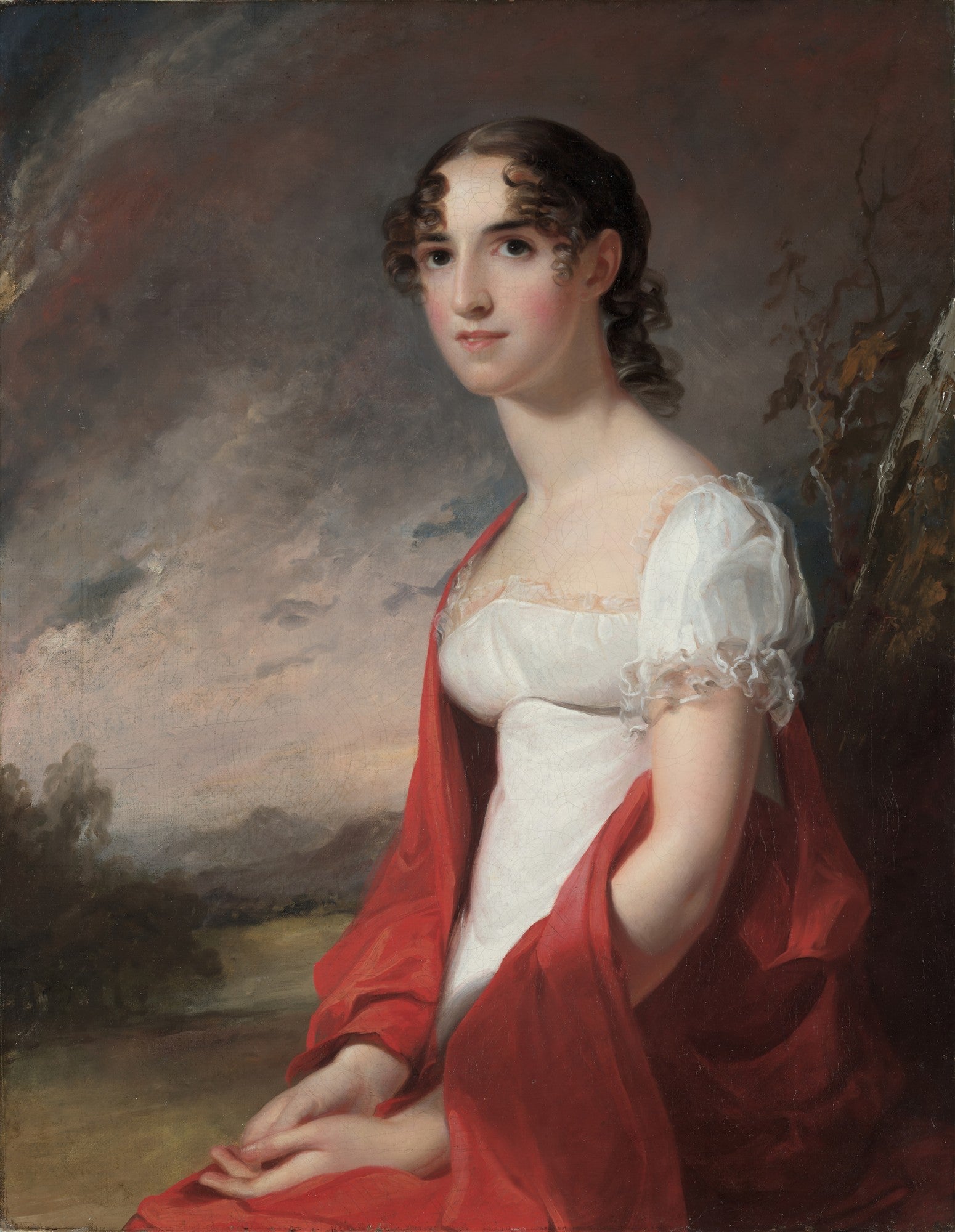 Retrato de uma mulher jovem do século XIX, com cabelo escuro cacheado, vestido branco e xale vermelho vibrante, sentada em frente a uma paisagem nebulosa. Obra atribuída a Thomas Sully.