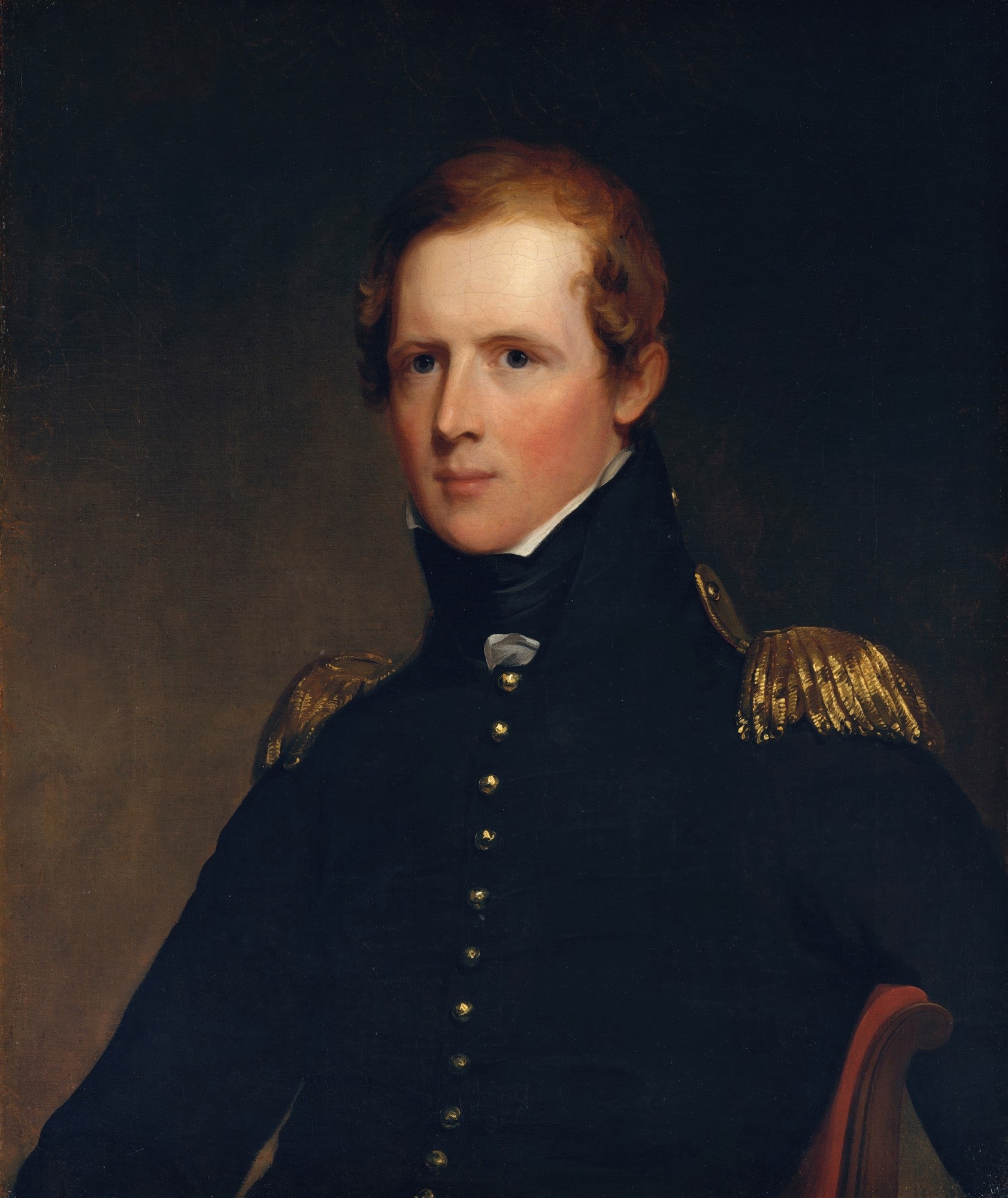 Retrato de um homem jovem com cabelo ruivo e olhos azuis, vestindo um uniforme militar azul escuro com detalhes dourados nos ombros, em estilo clássico do século XIX. O fundo é escuro e liso.